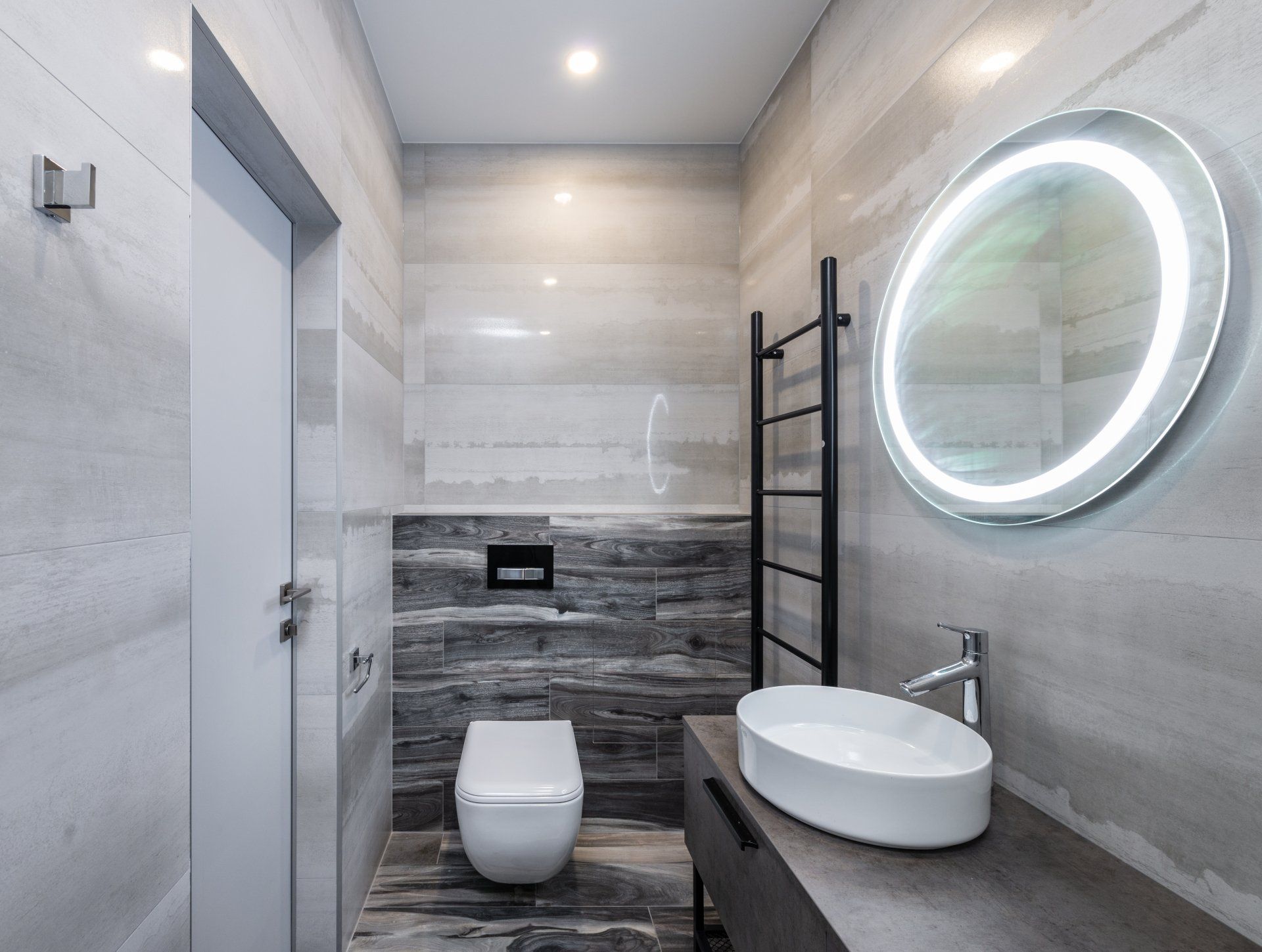 Een badkamer met toilet, wastafel en spiegel.