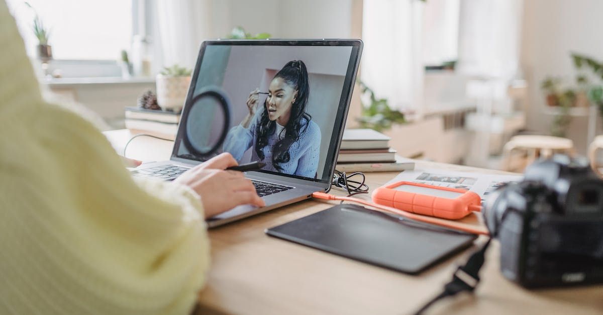 A person is sitting at a desk using a laptop computer.