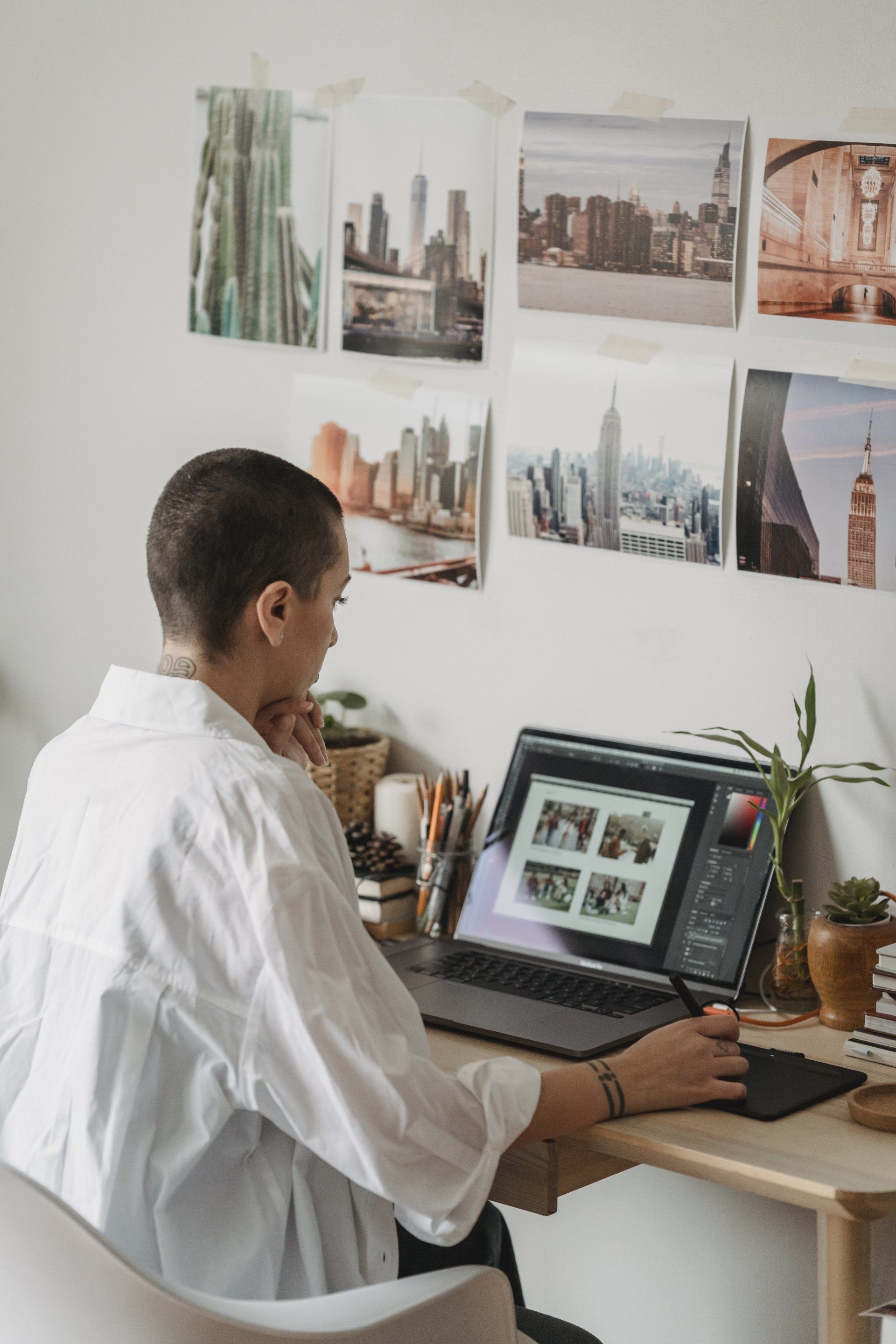 A man is sitting at a desk using a laptop computer.