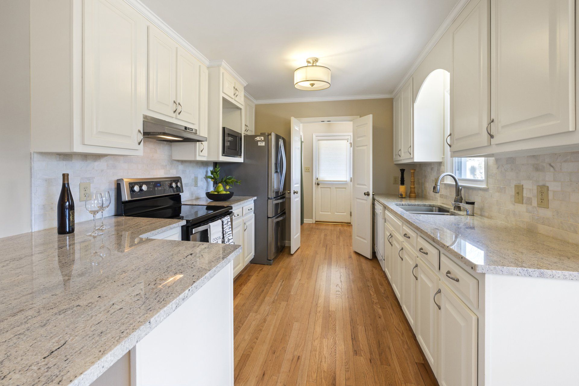 Gray glossy granite kitchen countertops with a sleek, modern finish.