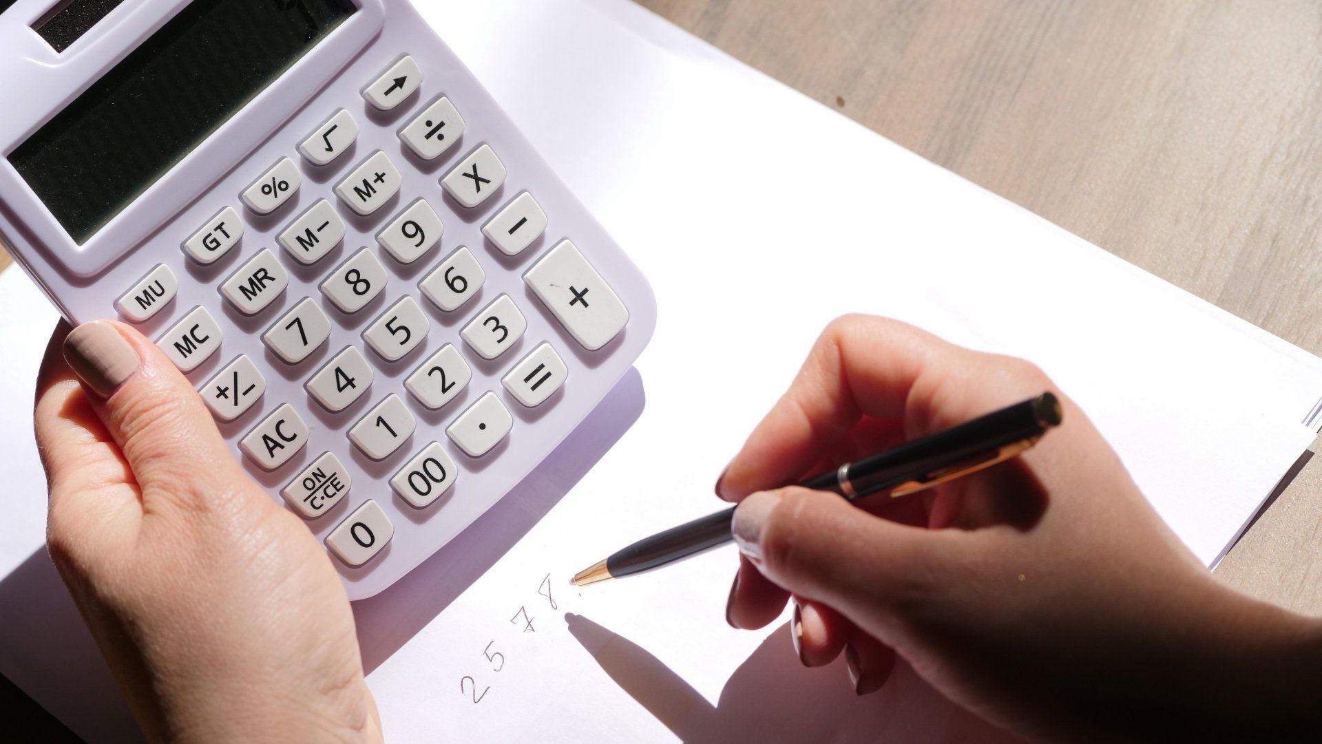 A Woman Holding a Calculator and Pen