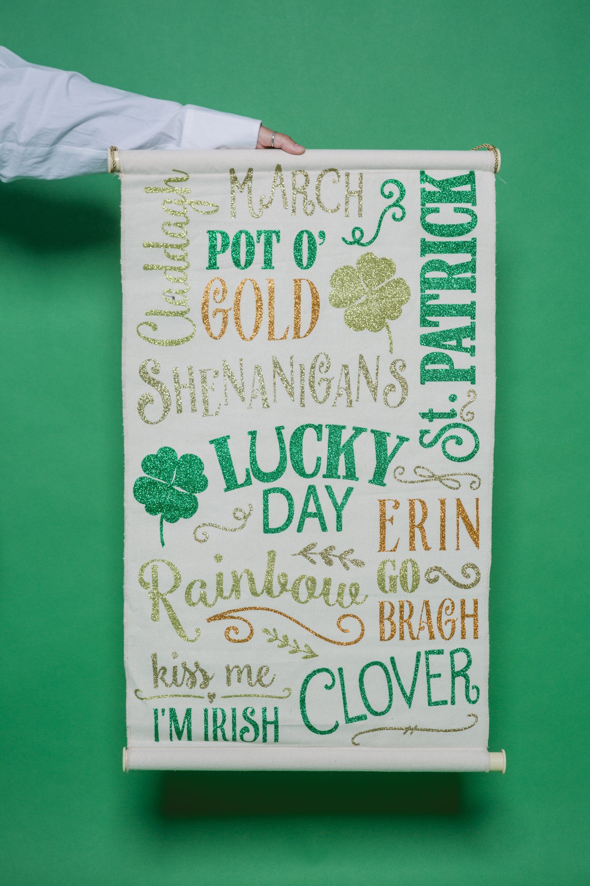 A person holding a scroll with words describing St. Patrick's Day