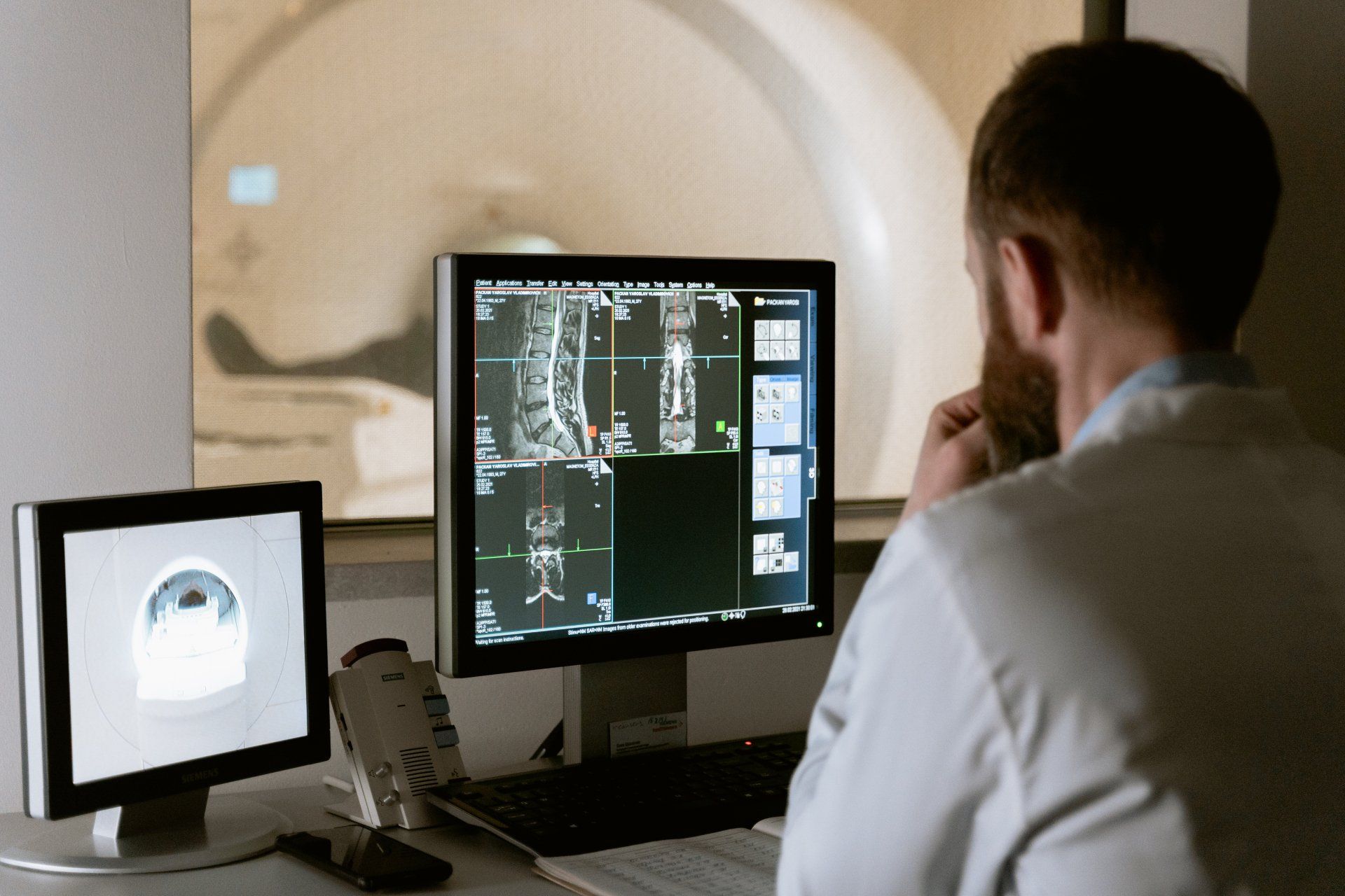 Doctor looking at scans on bones on a screen
