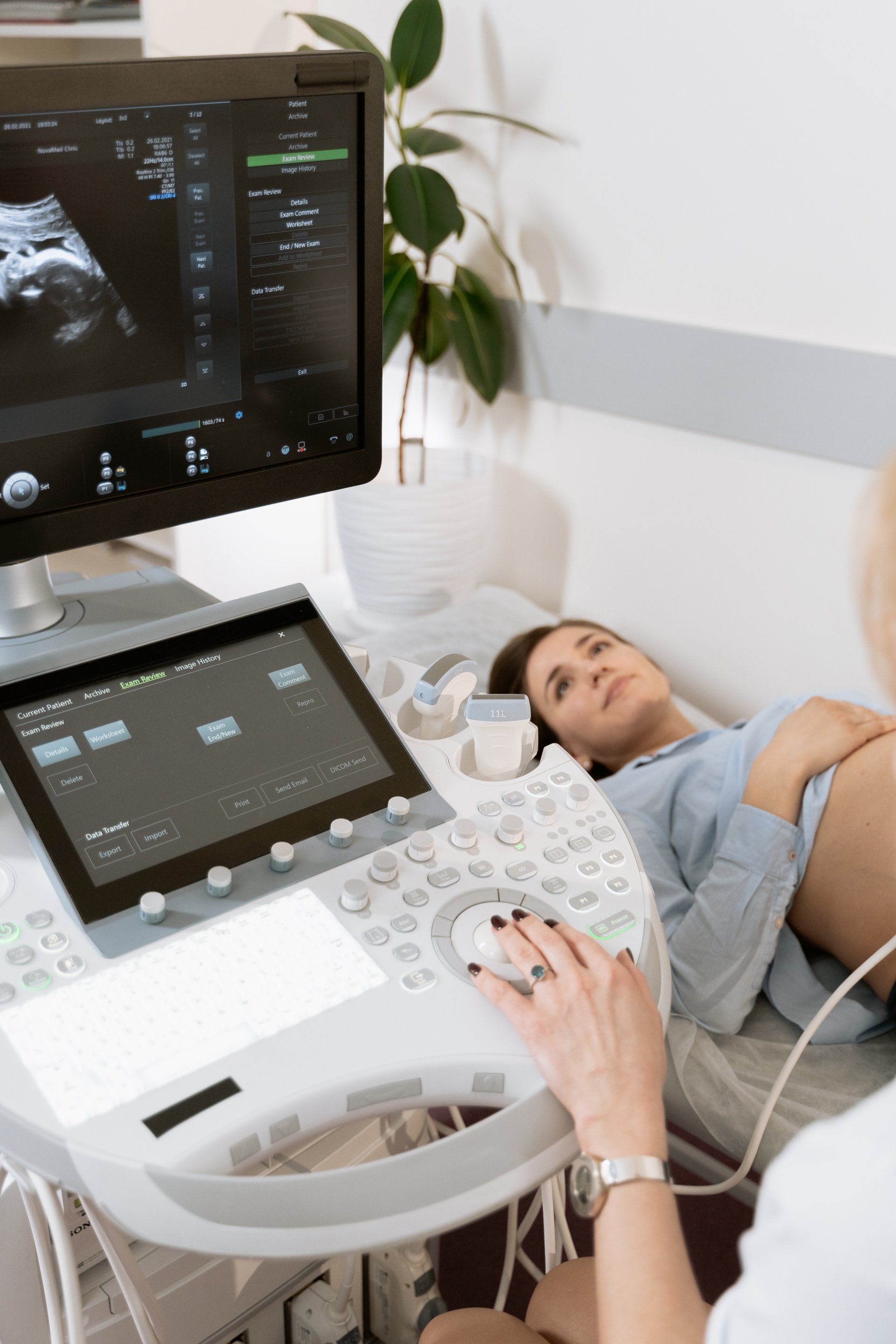 a pregnant woman is getting an ultrasound from a doctor