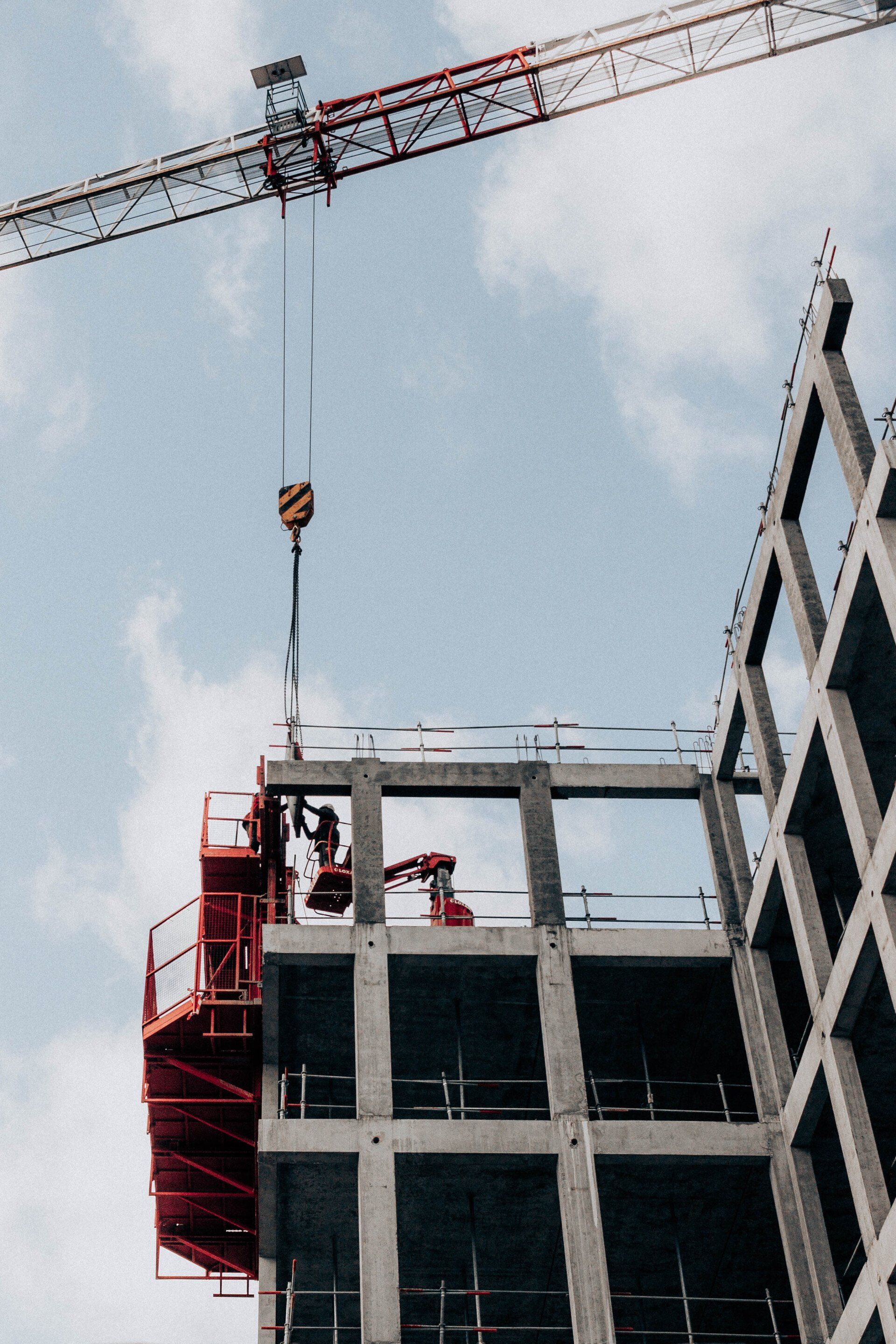 a construction crane is lifting a concrete structure