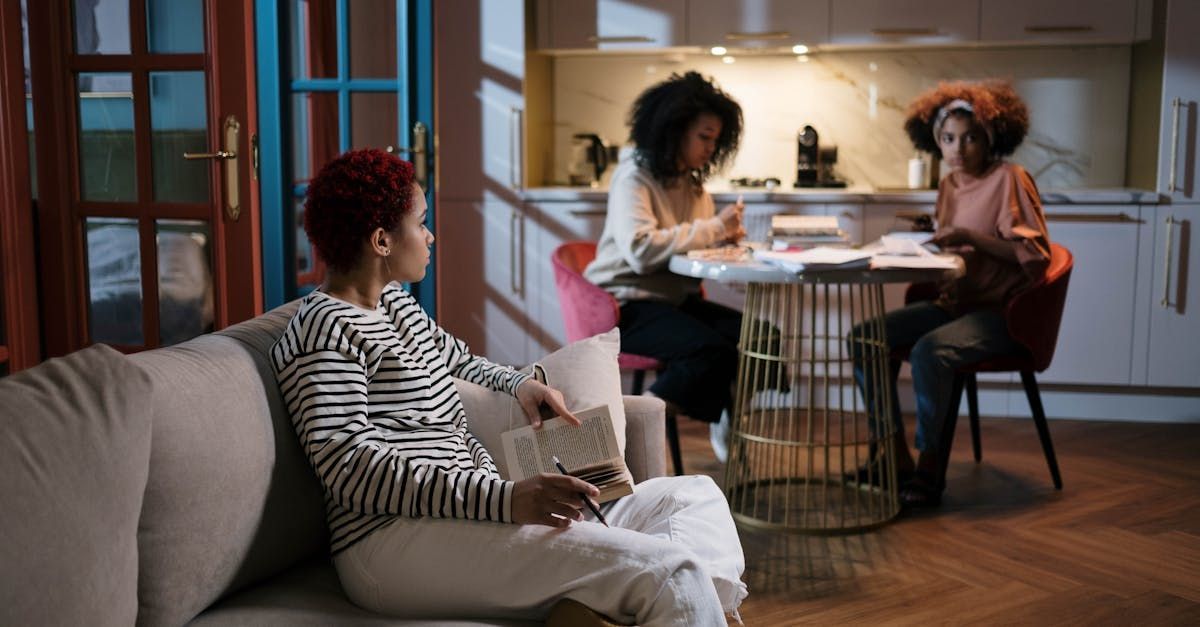 A group of women are sitting around a table in a living room.