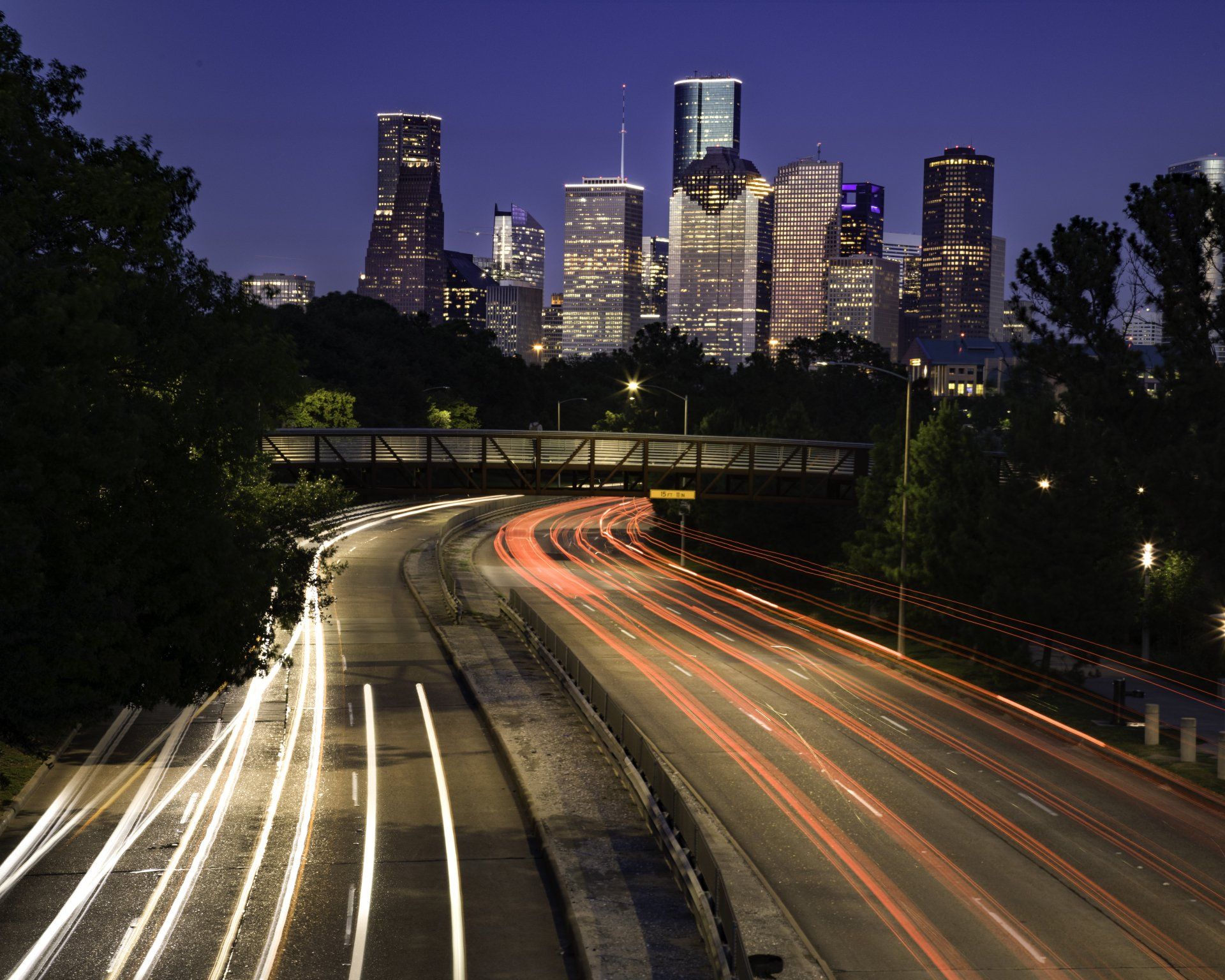 A highway at night with a city skyline in the background