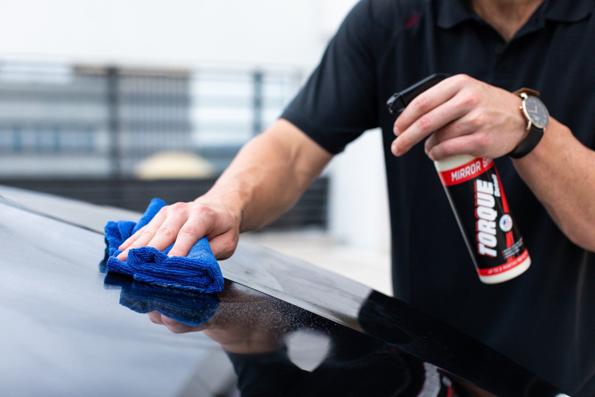 a person waxing a vehicle