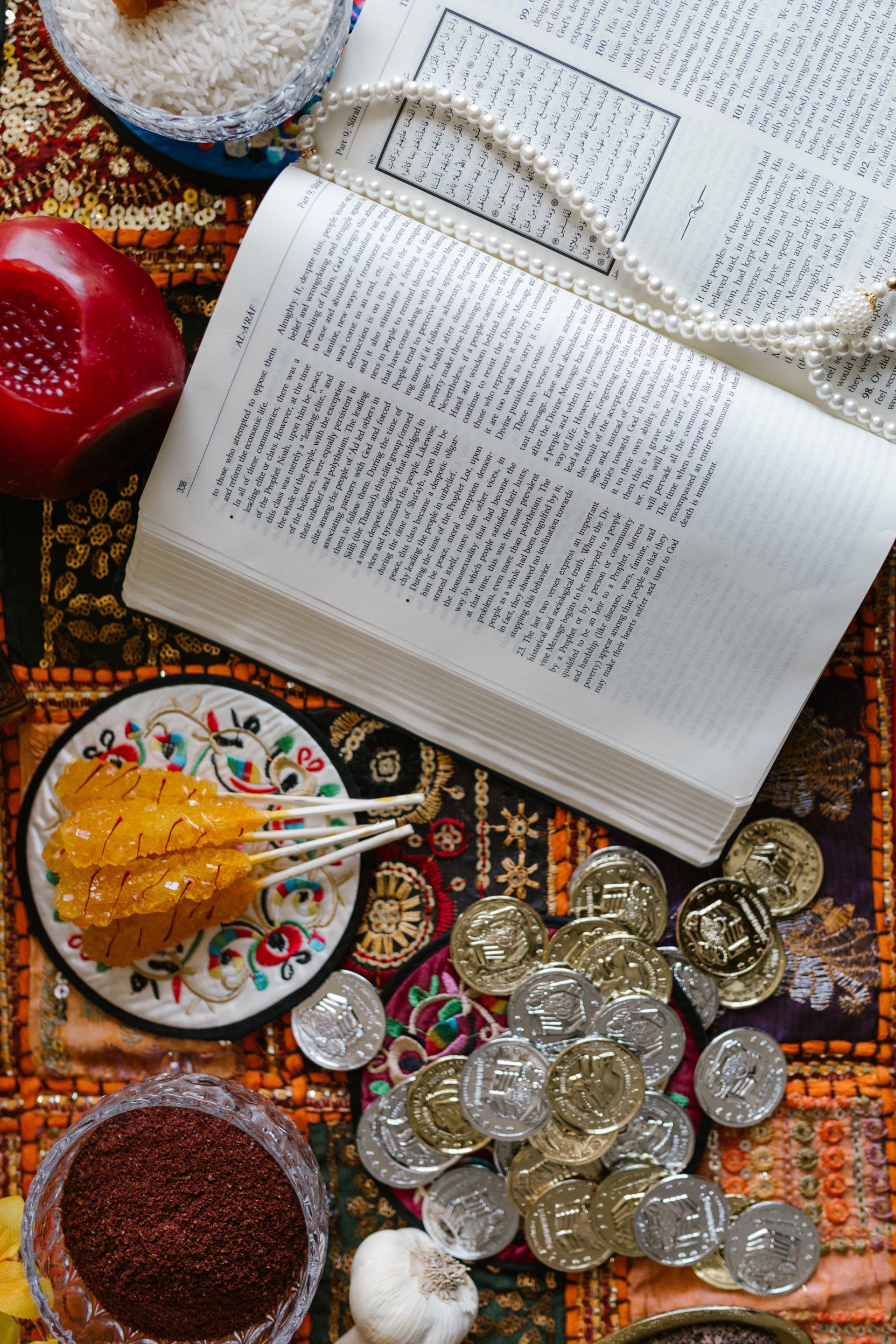 a Persian rug under a book and coins