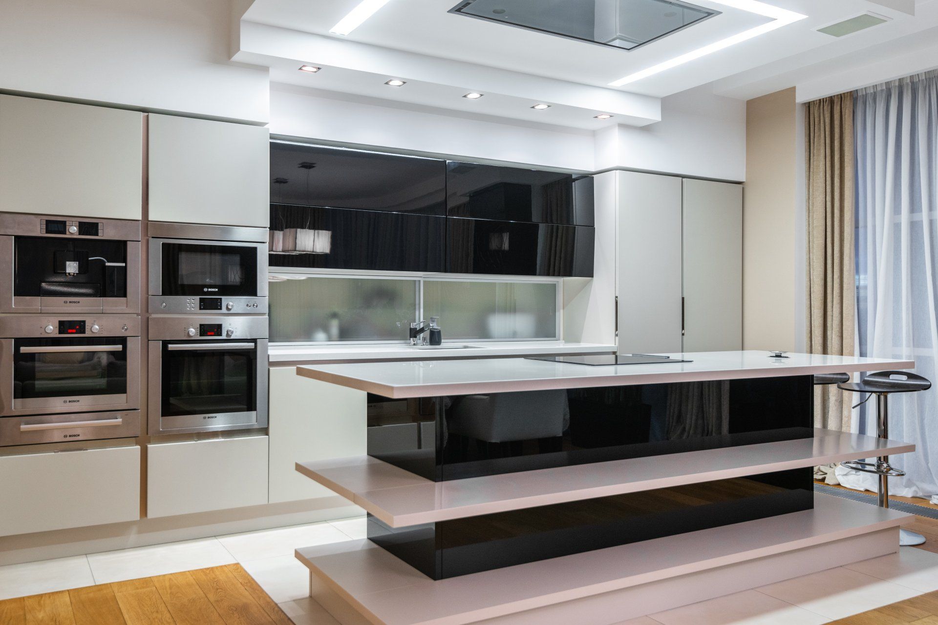 A kitchen with stainless steel appliances and a large island in the middle
