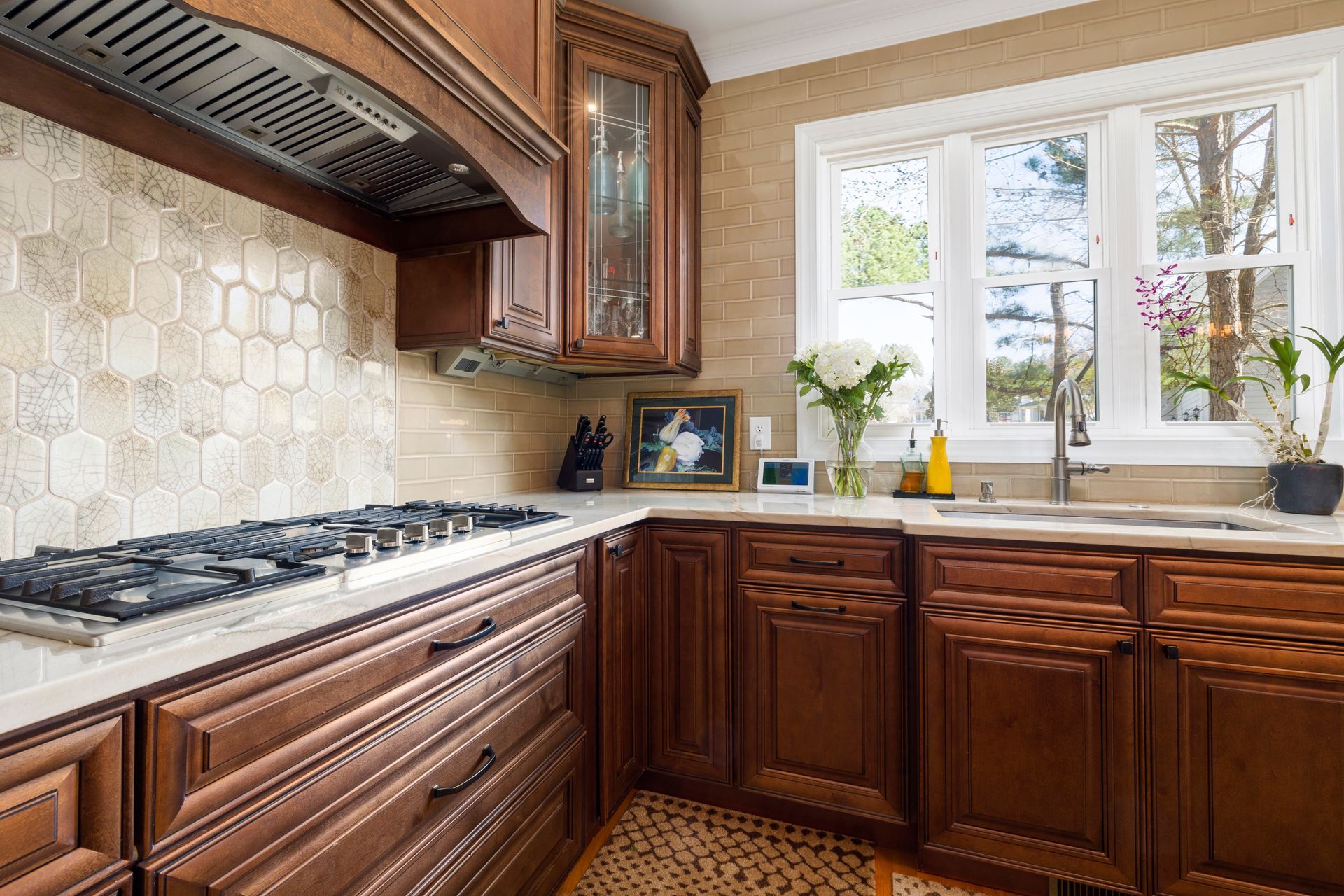 A kitchen with wooden cabinets and a stove top oven.