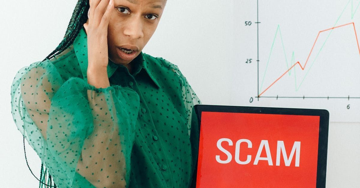 a woman in a green shirt is holding a sign that says scam .