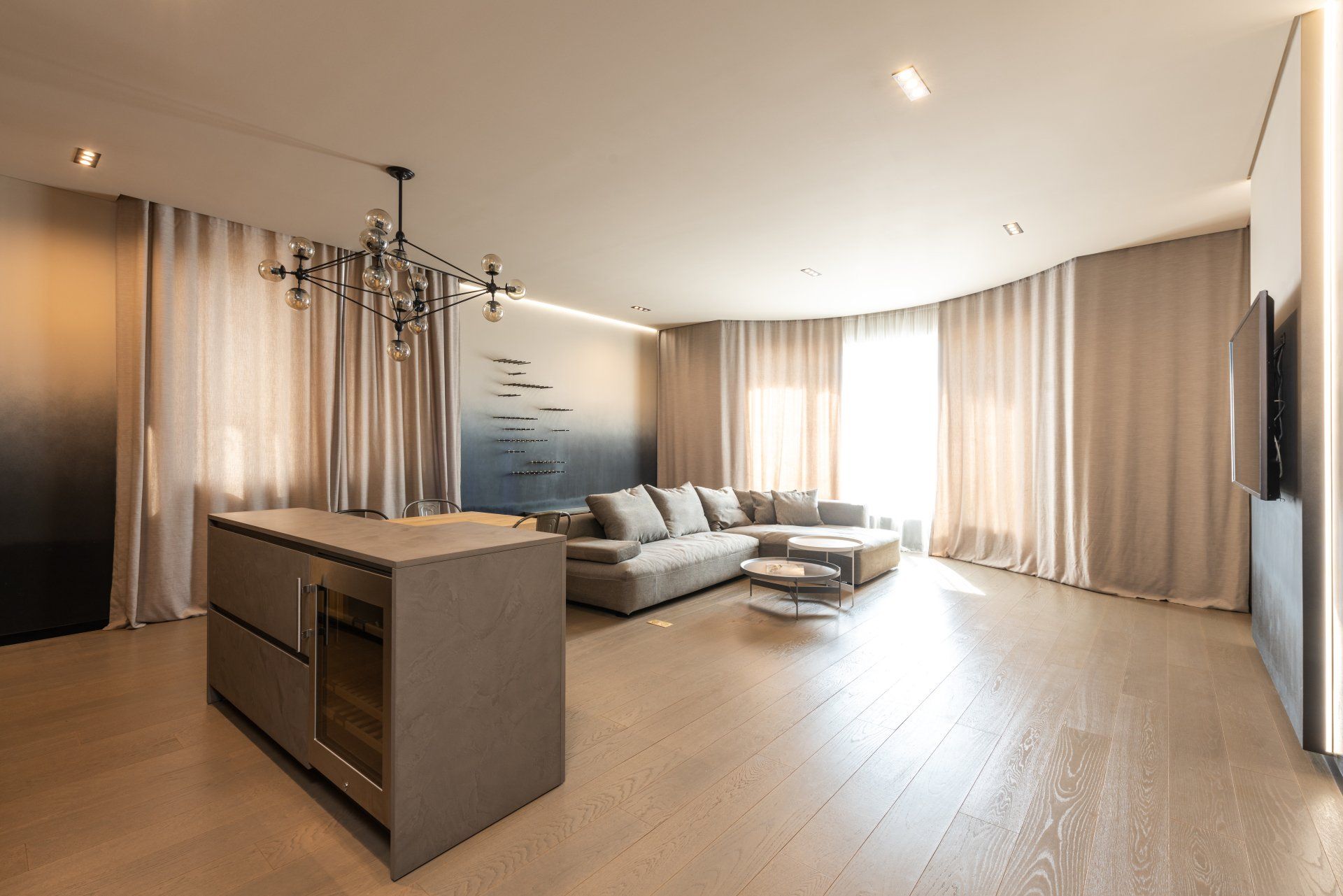 A living room with a couch , island , and television.