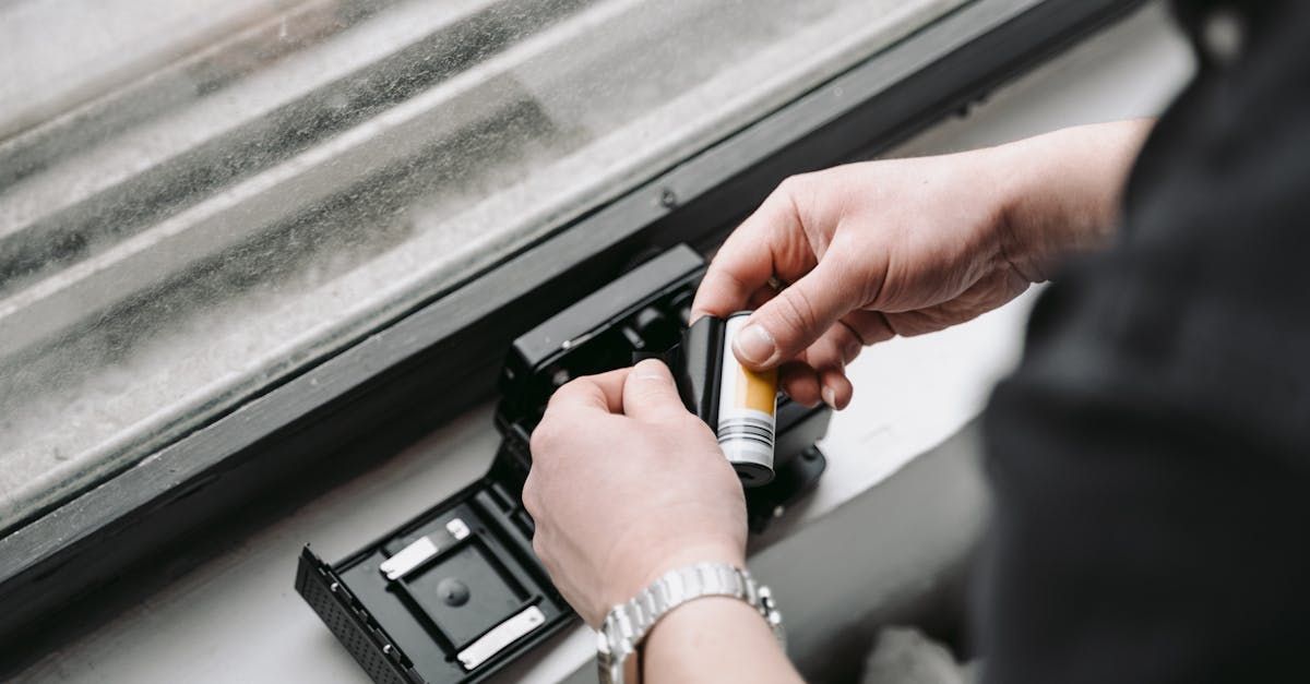 a person is adding a film into a camera.