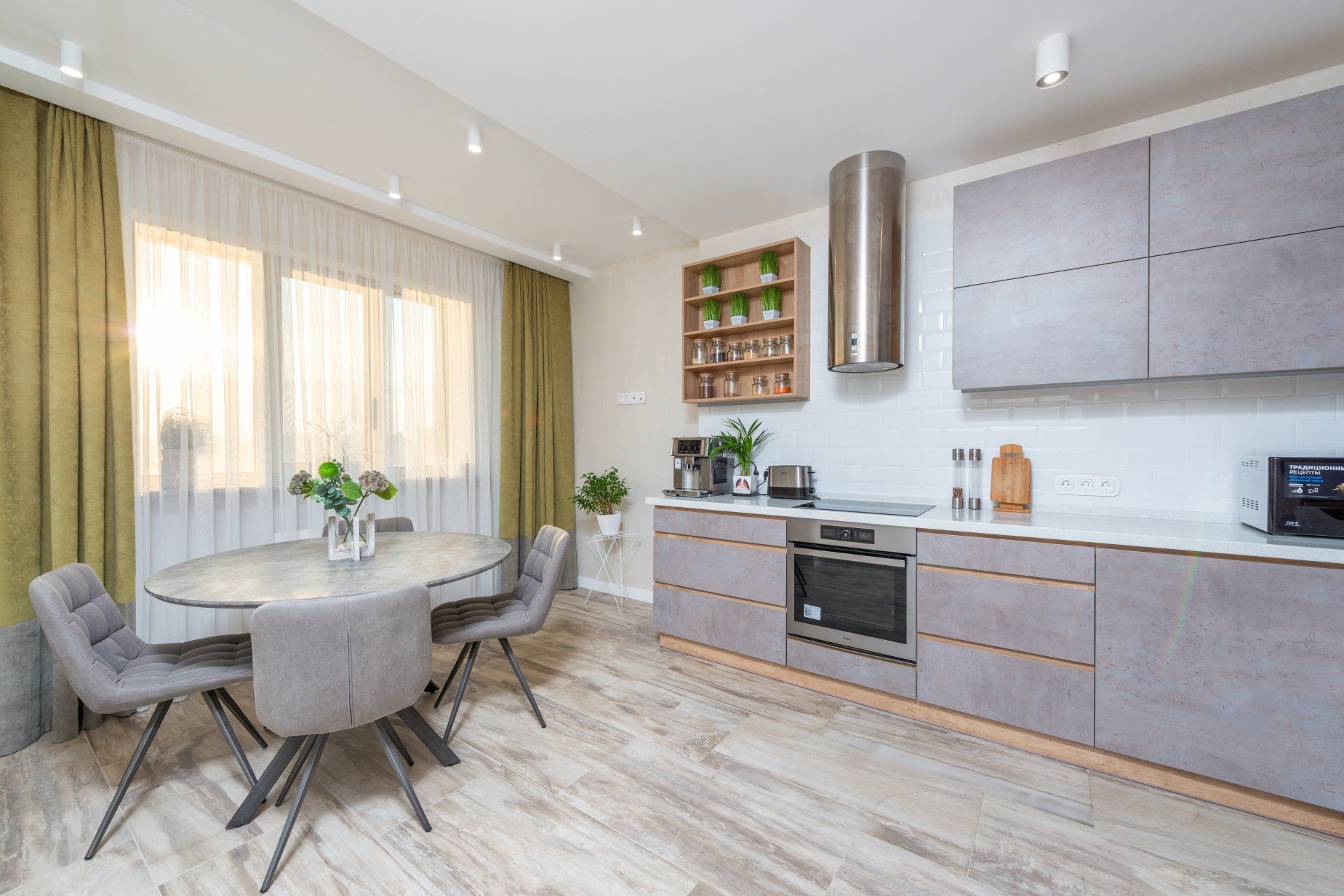 A kitchen with a dining table and chairs in it.