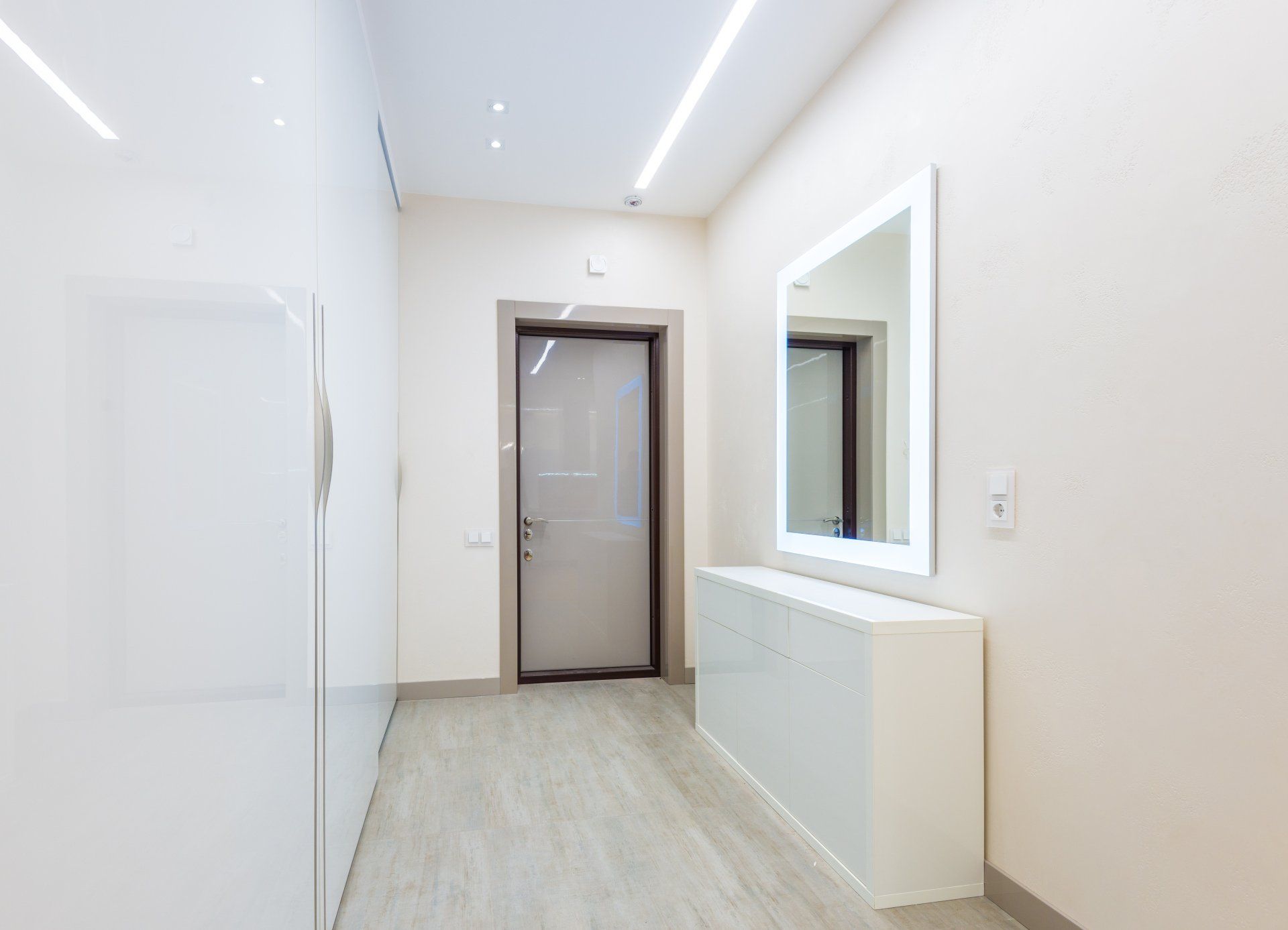 a hallway with a white door and a mirror