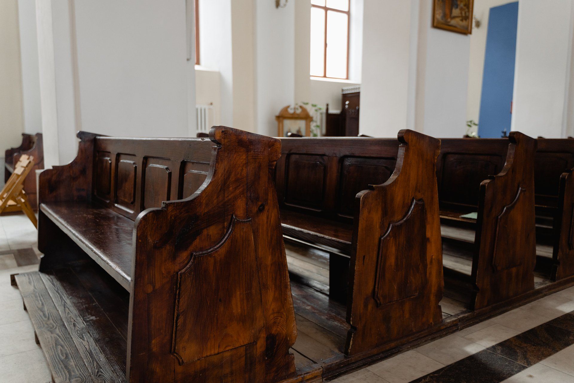 A row of wooden benches in a church.