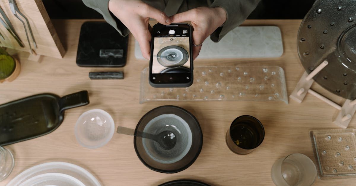 A person is taking a picture of a plate with a cell phone.