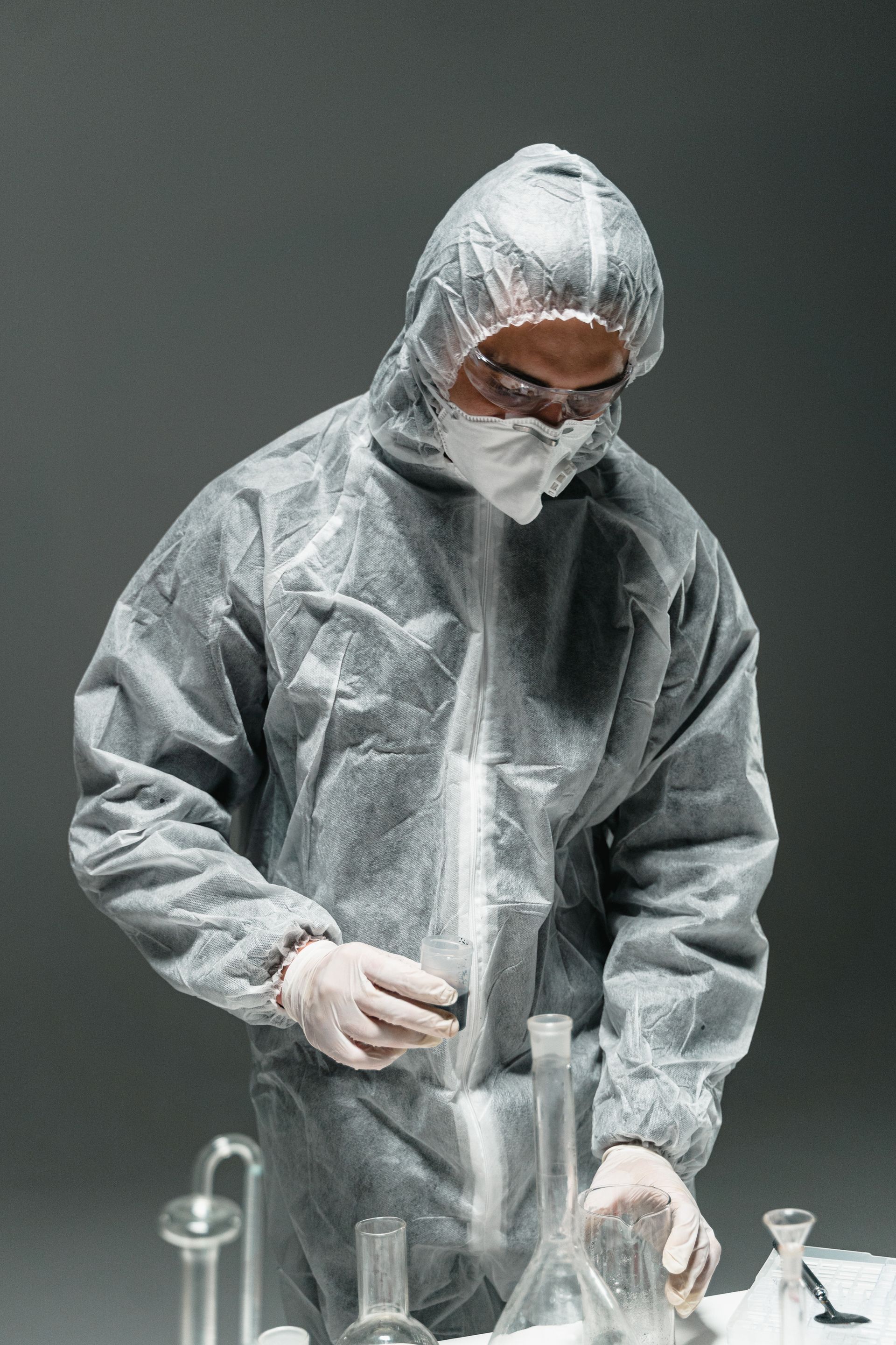 A scientist in a protective suit is working in a laboratory.