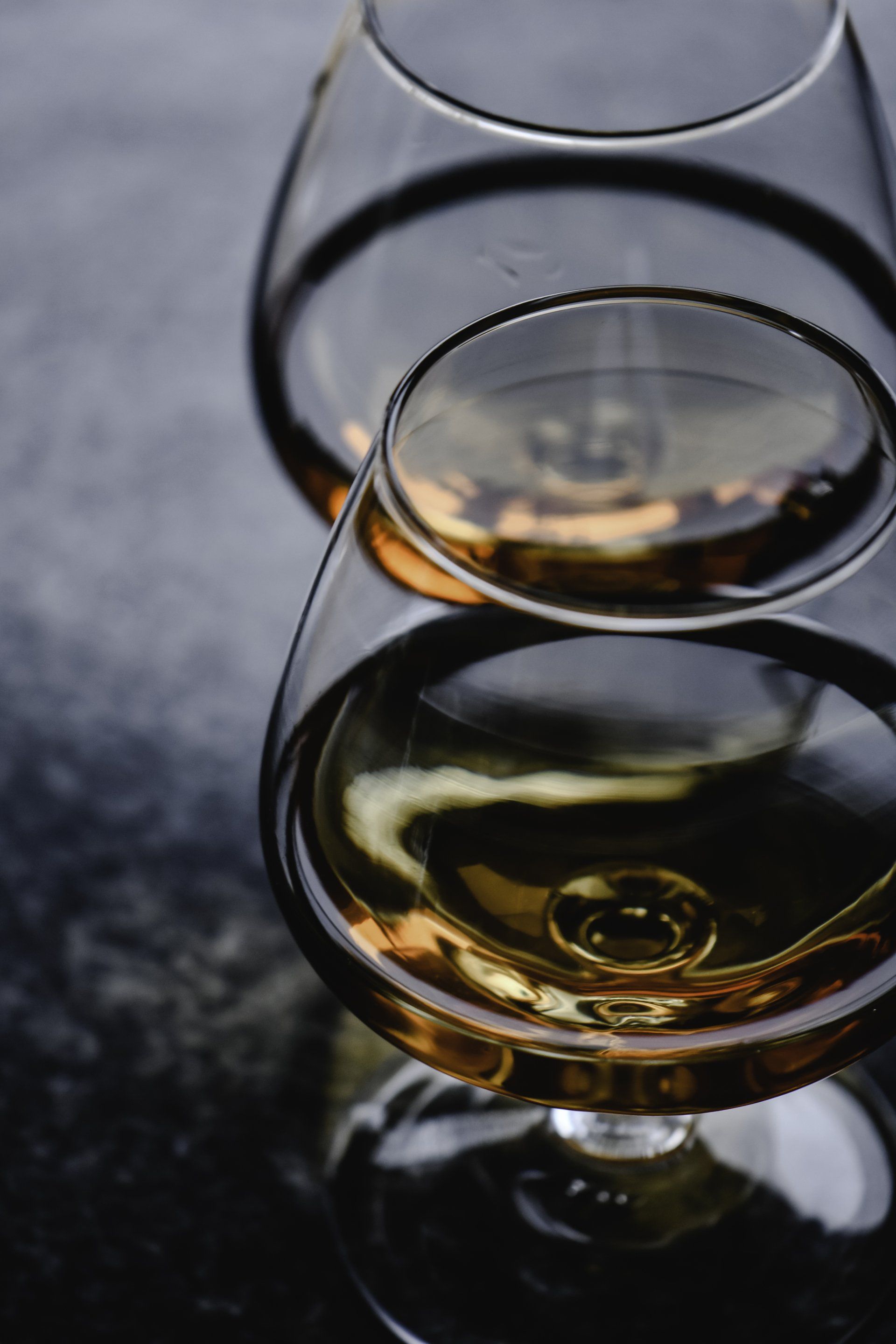 Three glasses of cognac are stacked on top of each other