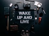 A sign that says wake up and live on it