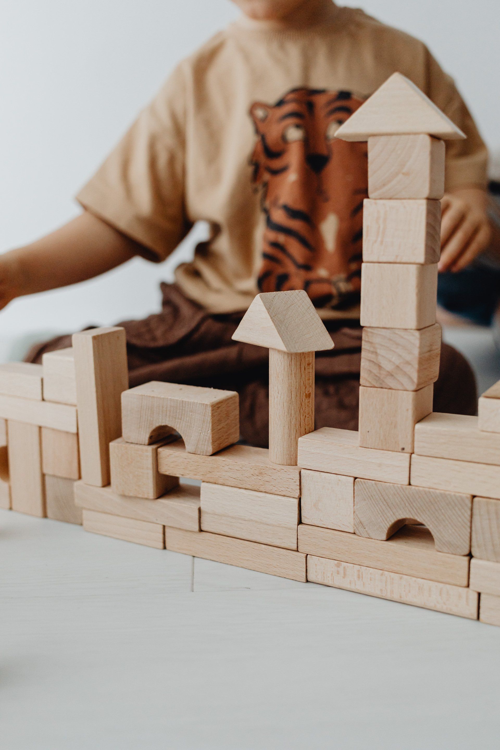 Kid playing with wooden building blocks