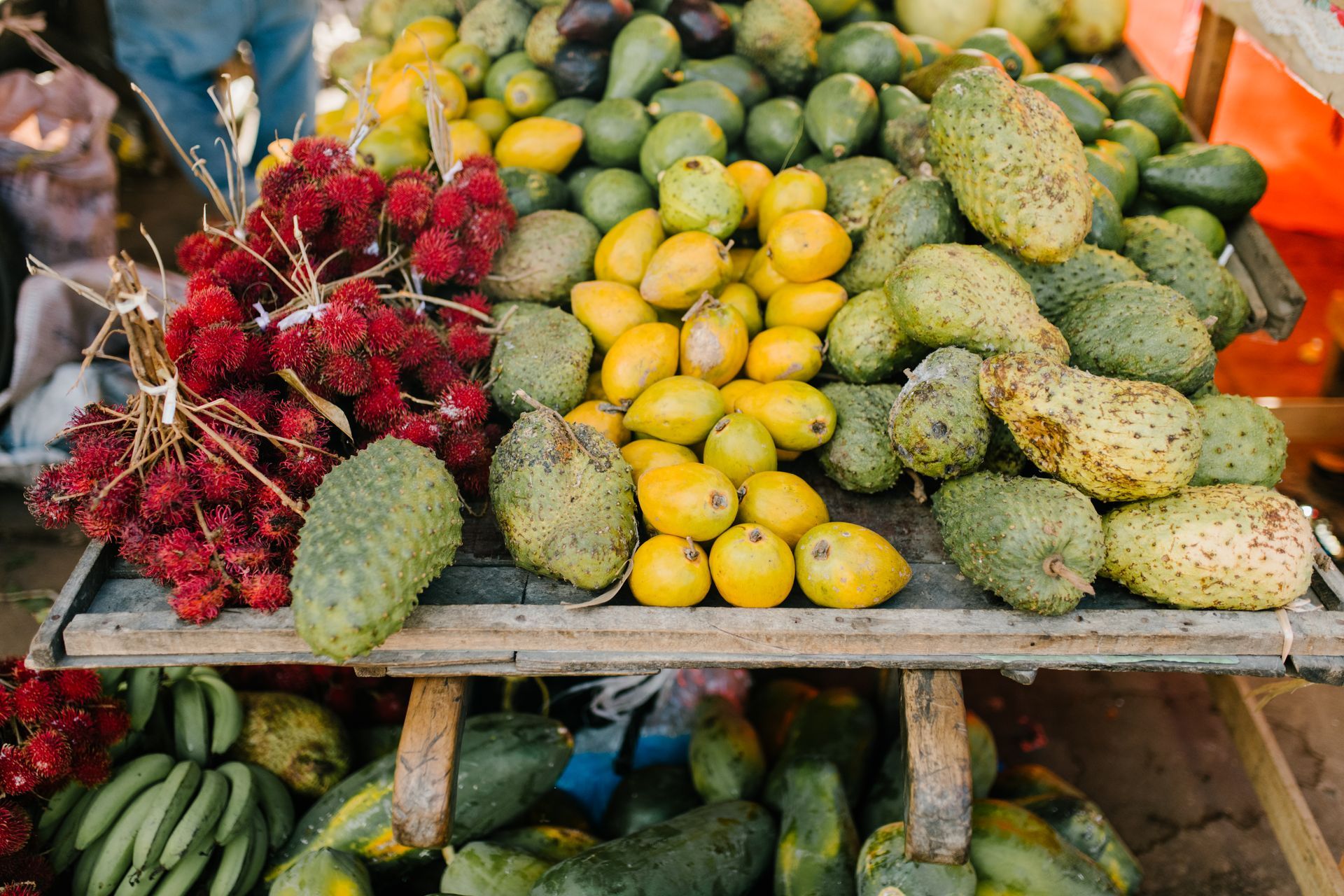 a variety of fruits and vegetables are displayed on a wooden table .