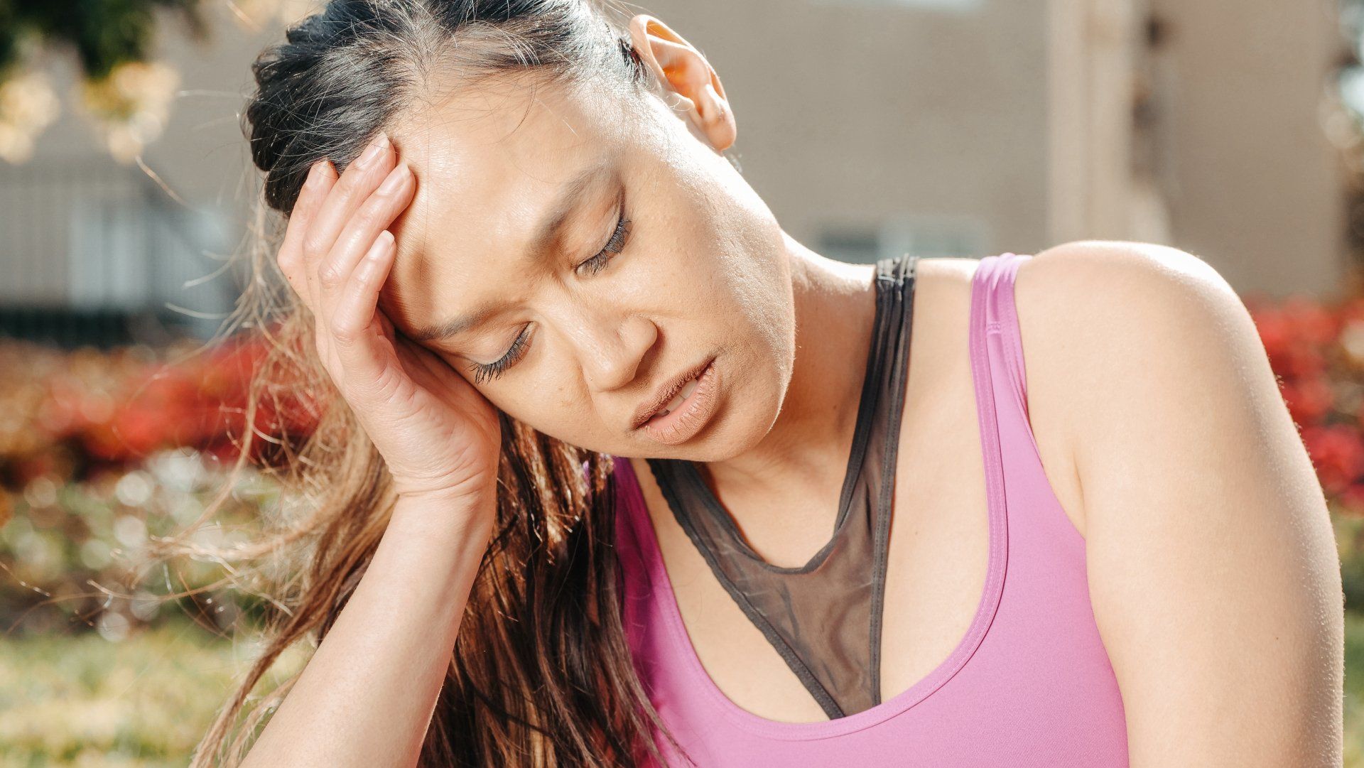 woman with migraine holding head