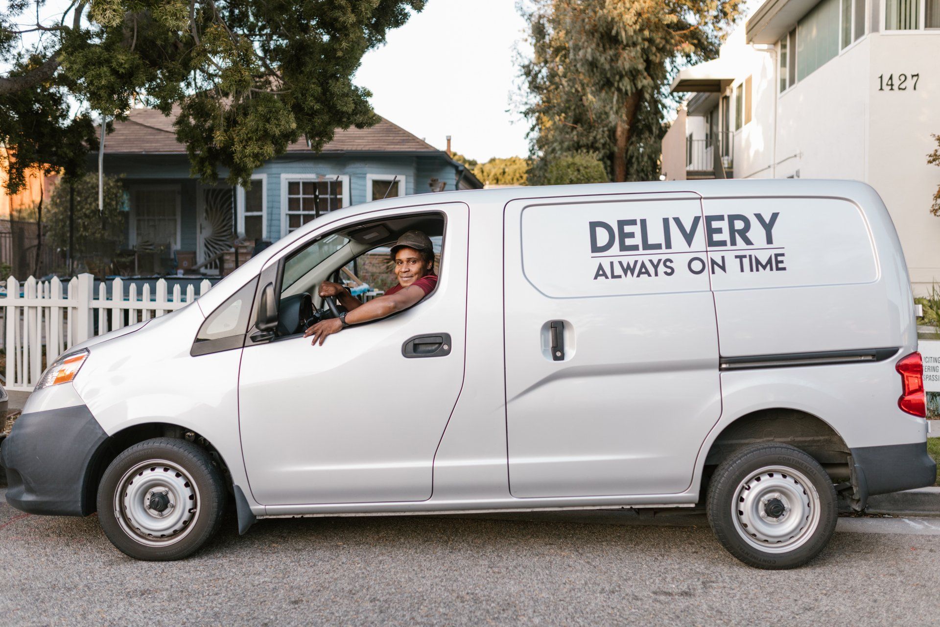 a delivery van is parked in front of a house .