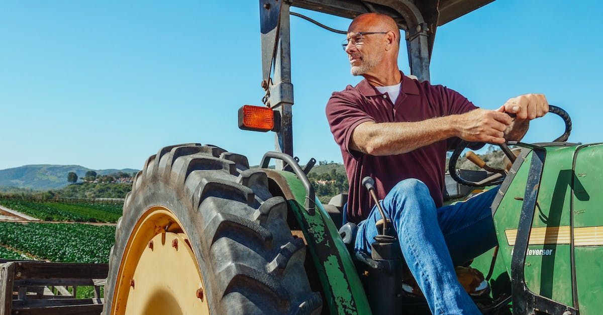 A Man is Sitting on a Tractor in a Field — Mick Sawtell Electrical Pty Ltd in South Lismore, NSW