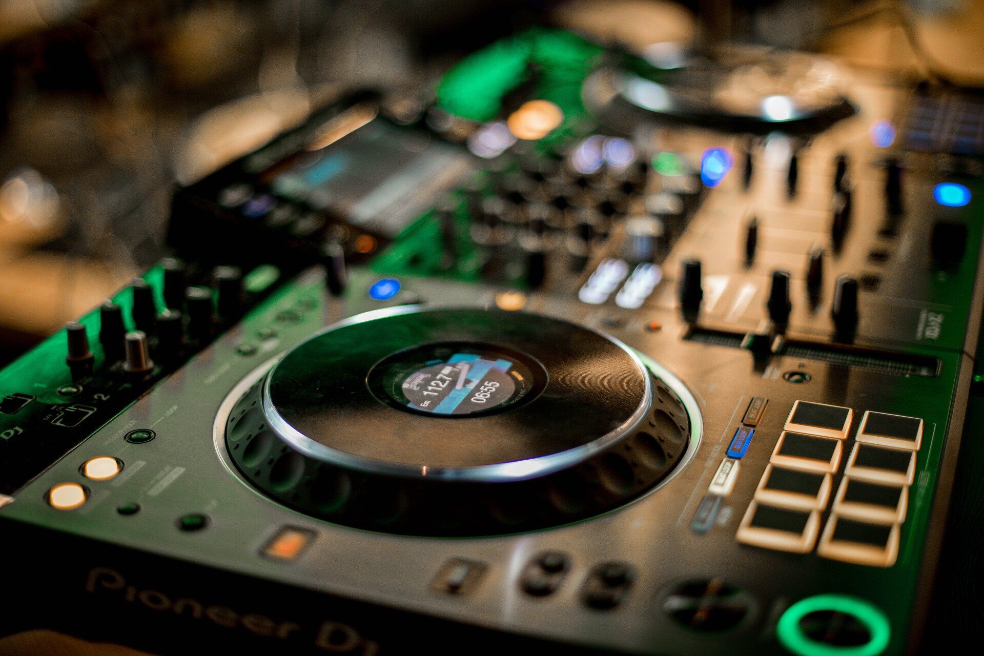 A close up of a pioneer dj controller on a table.