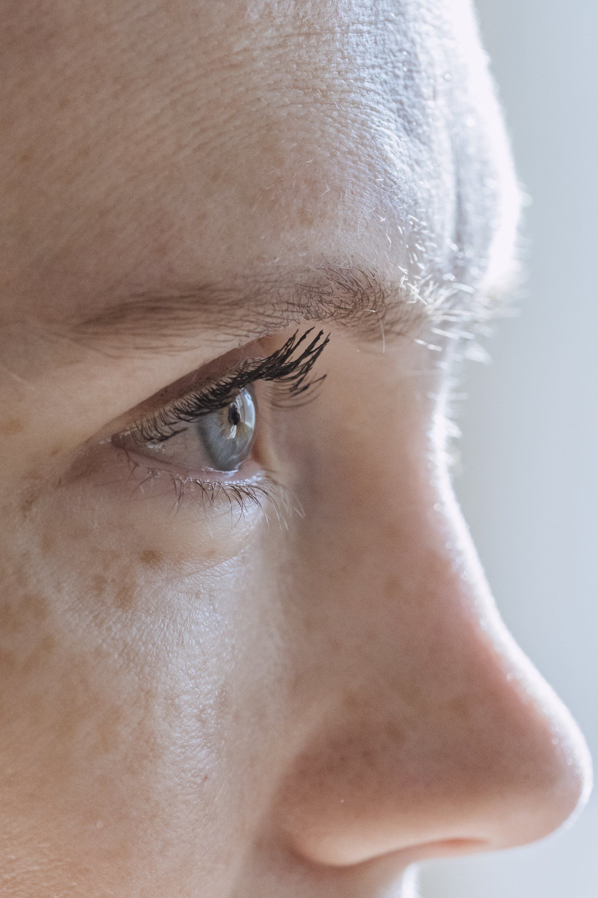 A close up of a woman 's eye and nose.