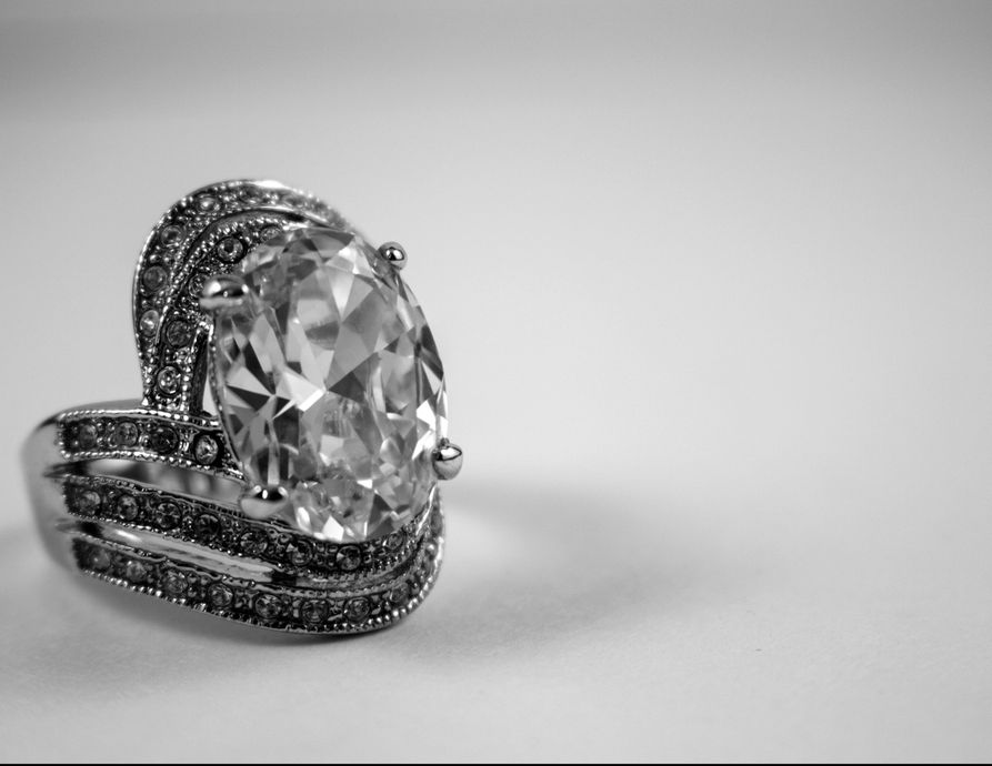 A black and white photo of a diamond ring