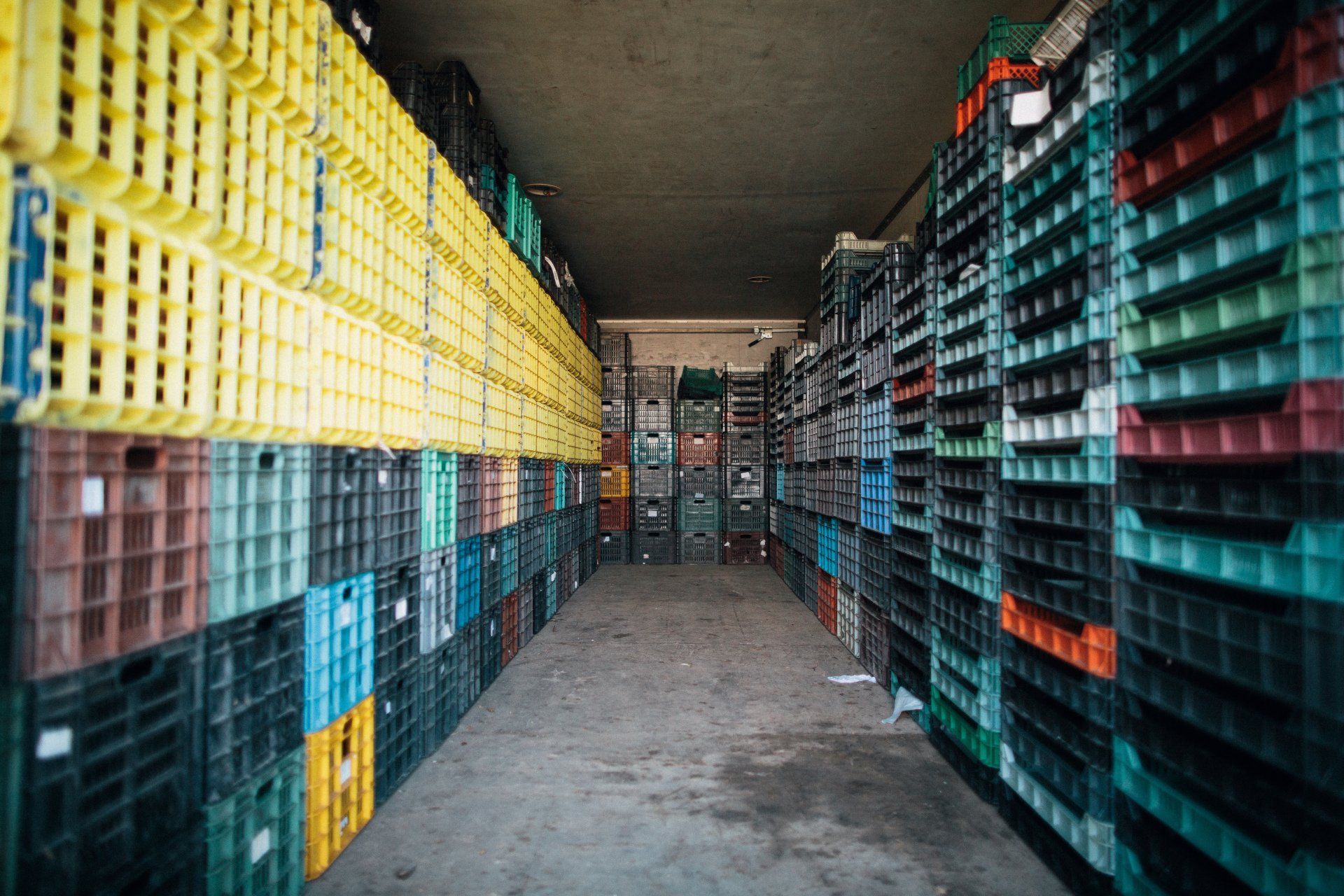 A warehouse filled with lots of colorful plastic crates.