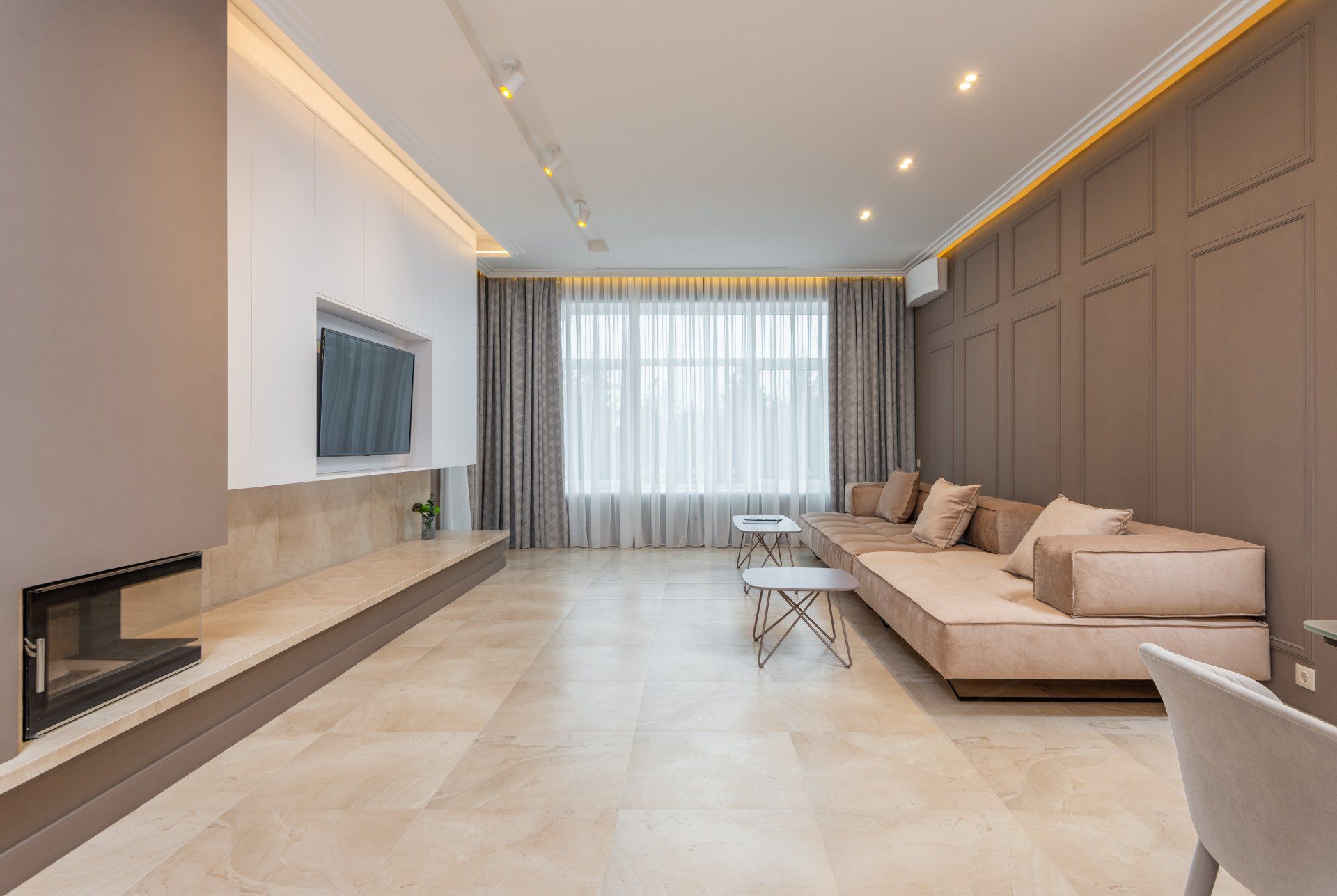A living room with a couch , fireplace , and television.