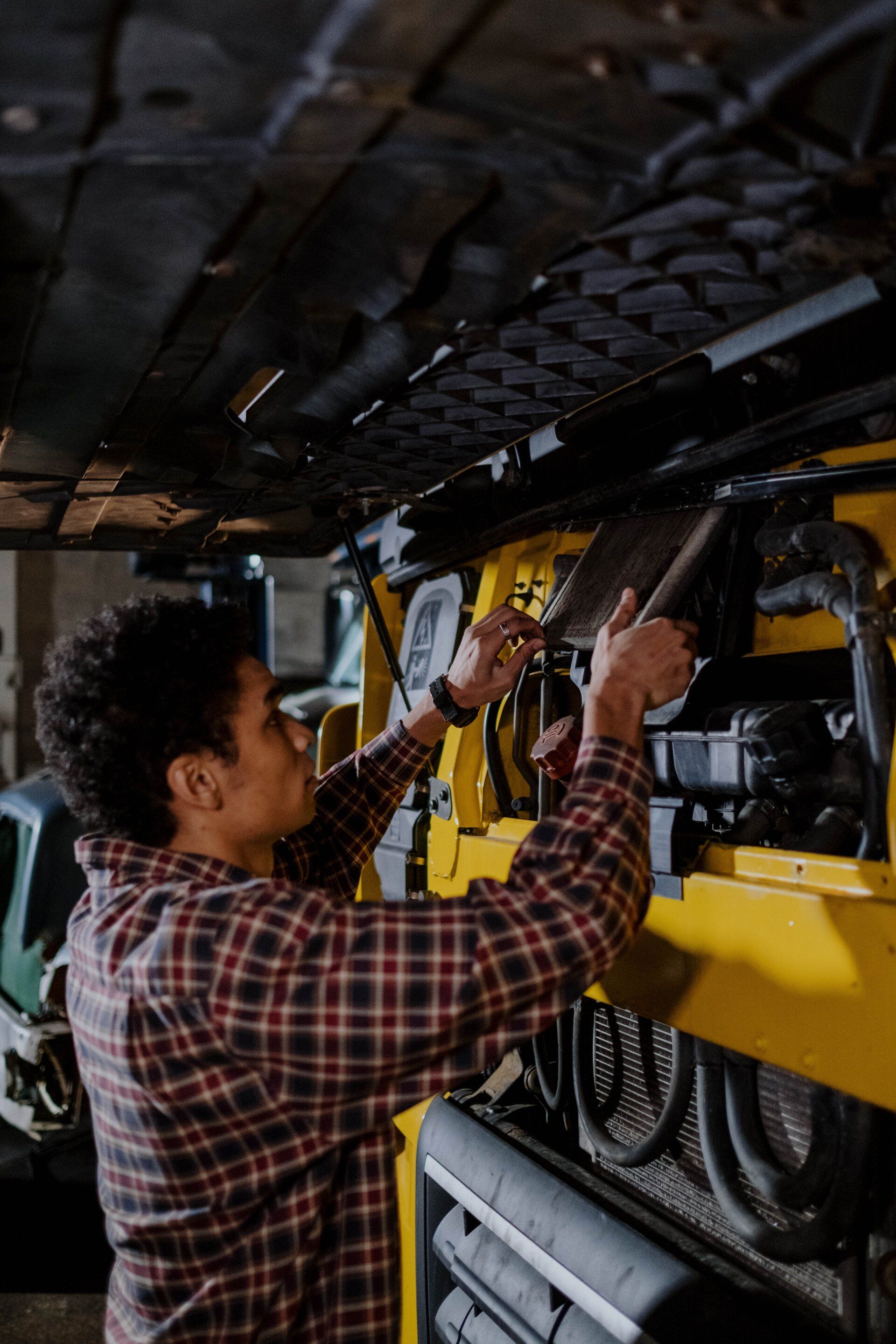 Guy fixing car's engine 