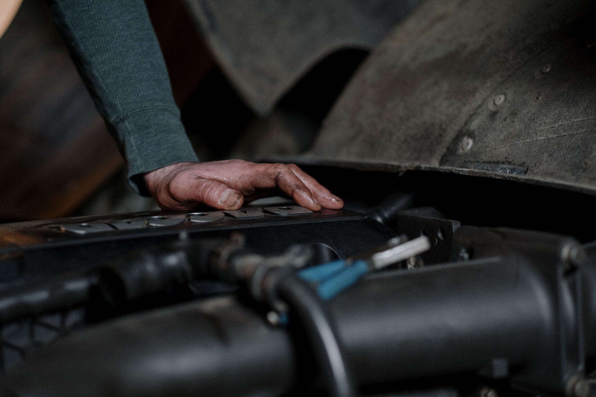 a person checking a vehicle's engine