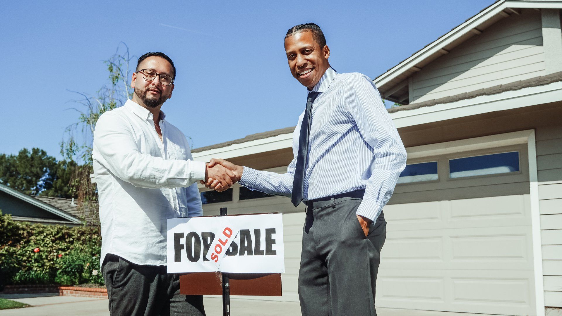 Realtor shaking hand with home buyer