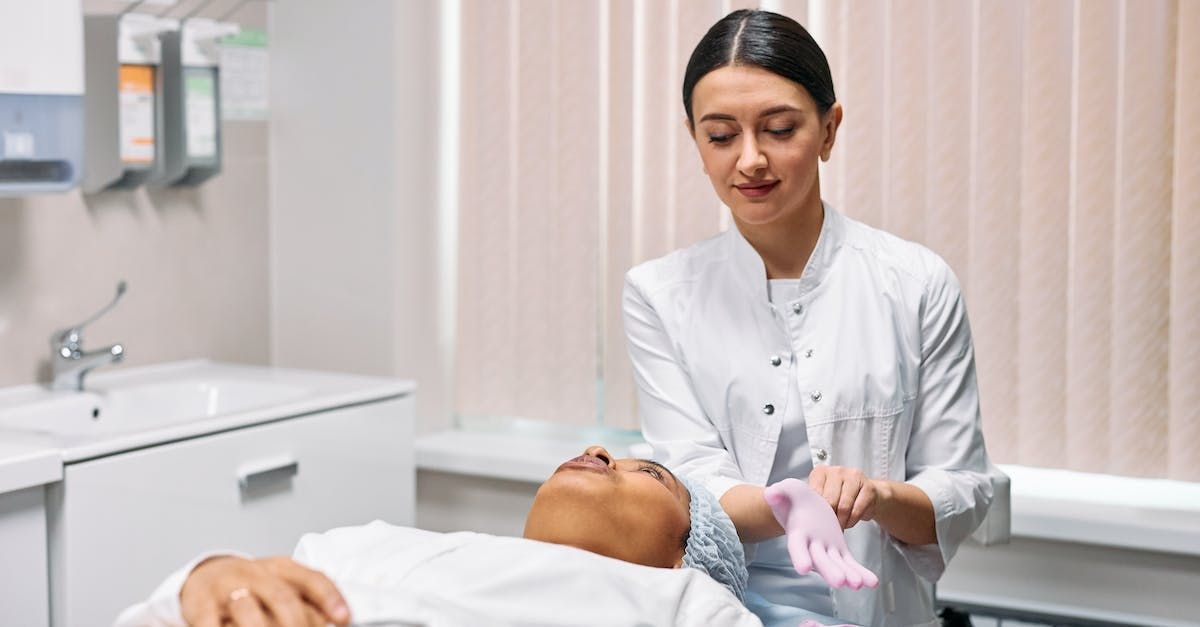 A woman is giving a man a facial treatment in a beauty salon.