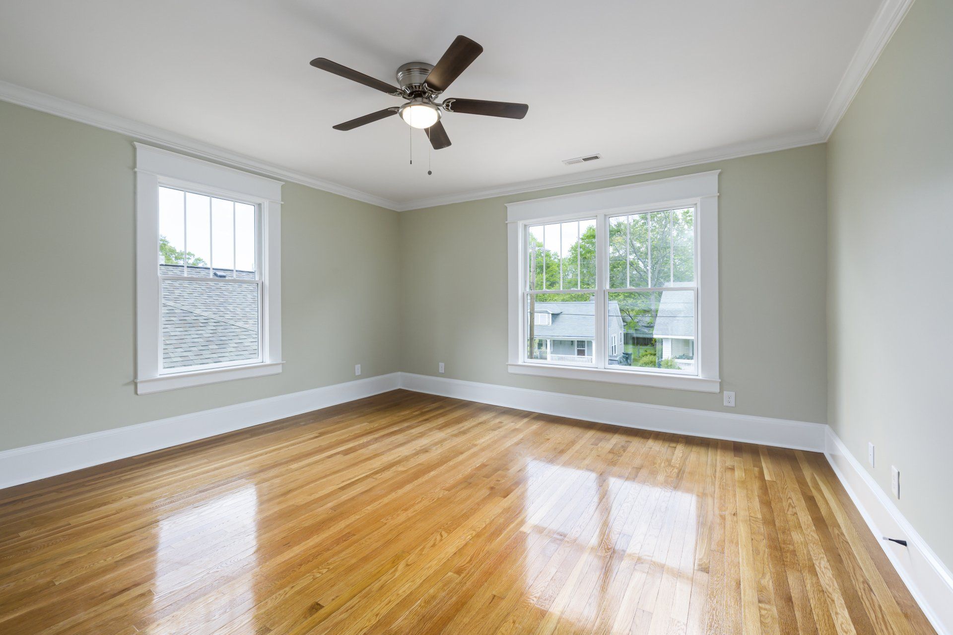 Ceiling fan with light hanging from the center of the room, providing a cool breeze and illumination.