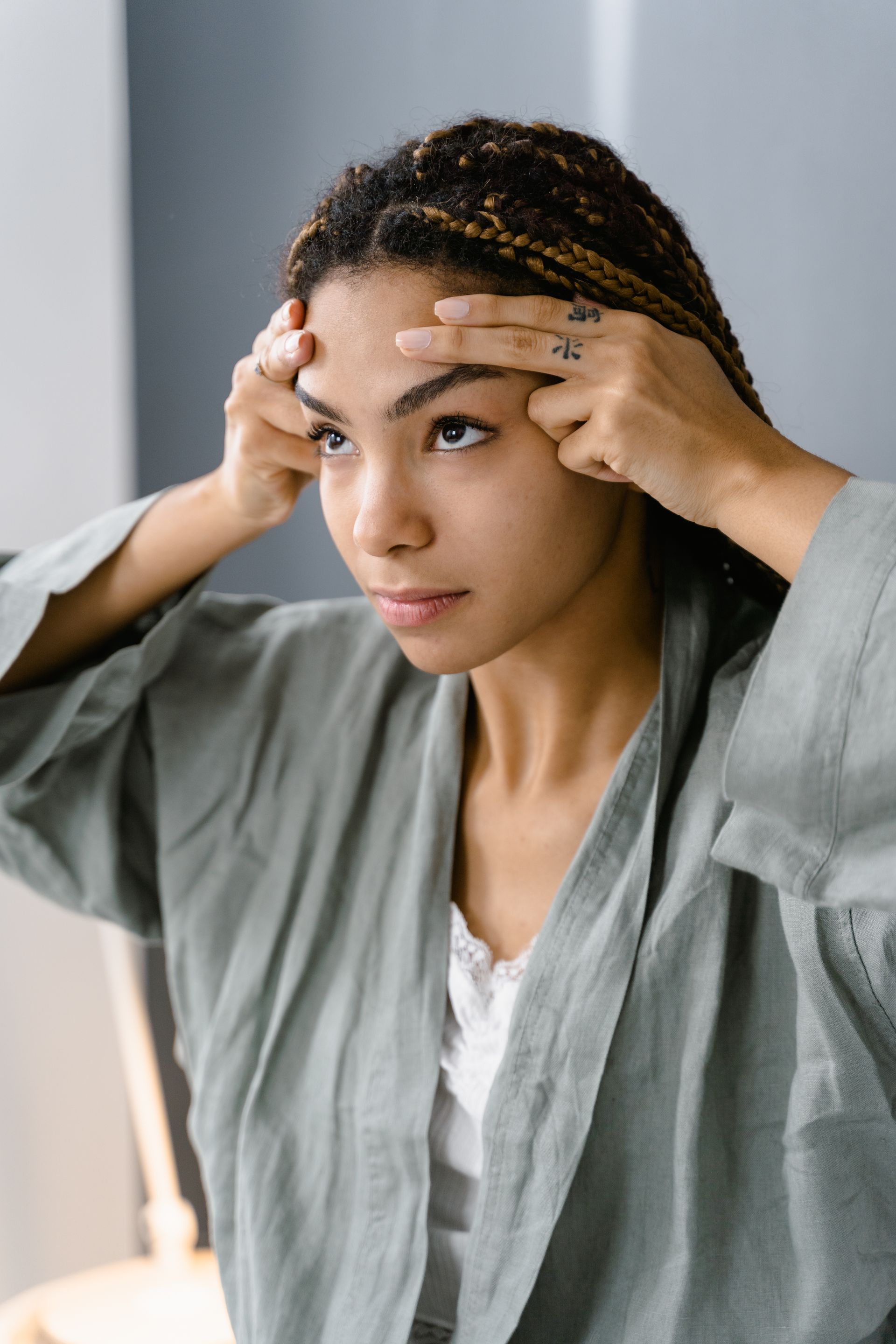 A close-up photo of a woman's face with a balanced forehead and other facial features, showcasing the results of forehead reduction surgery.