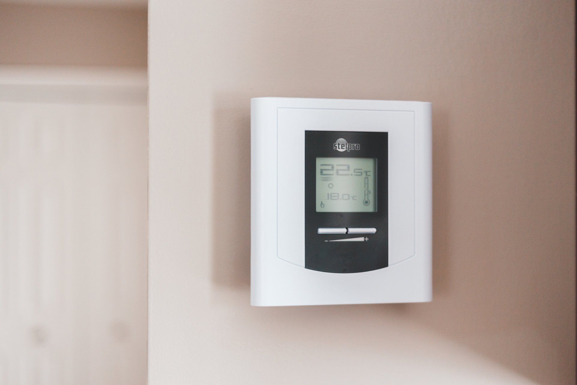 A stetpro thermostat on an off-white wall