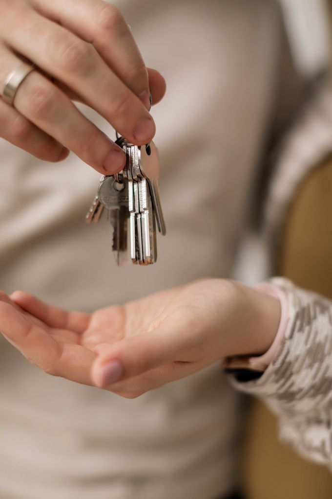 A person is holding a bunch of keys in their hand.