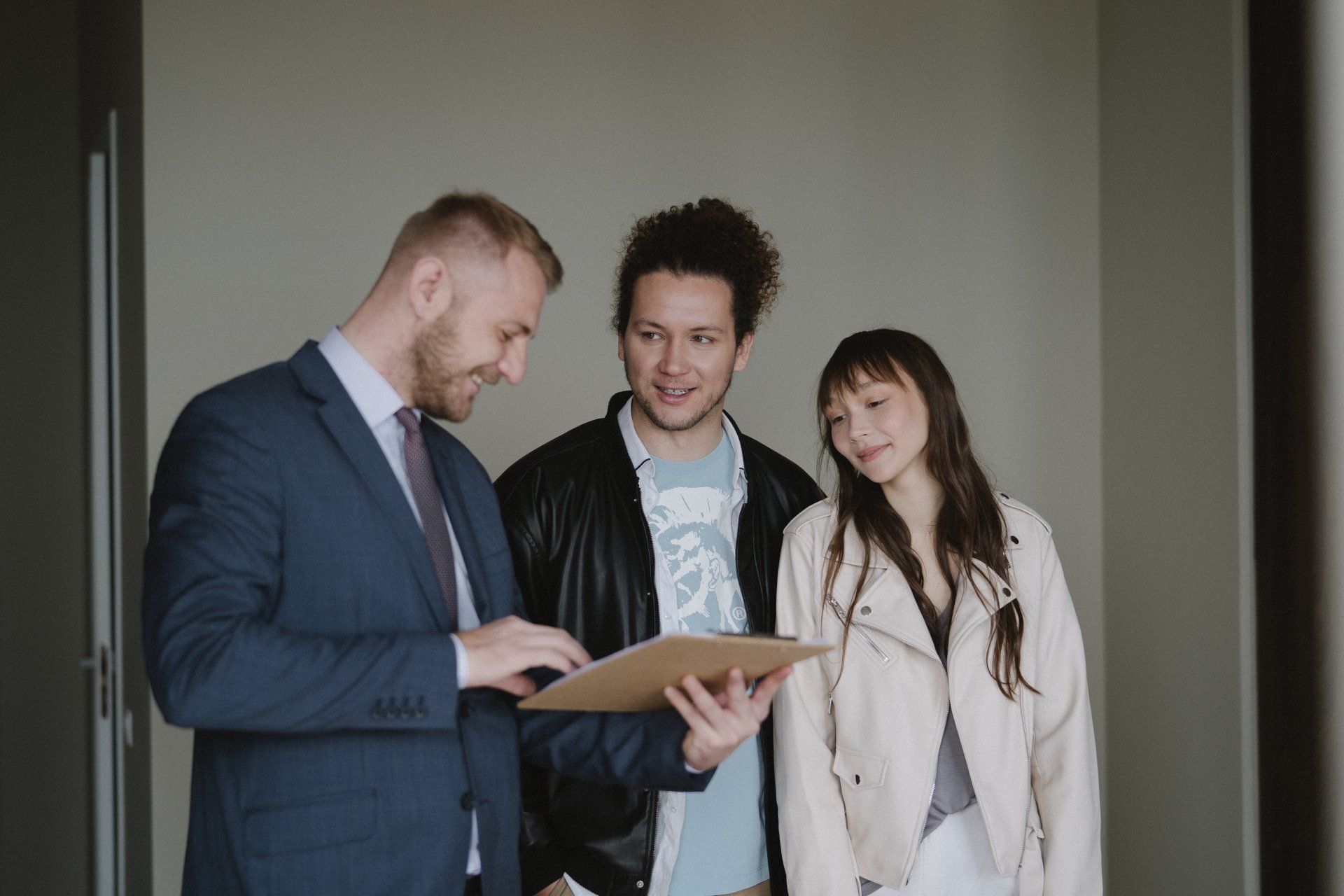 An agent showing a couple a new apartment
