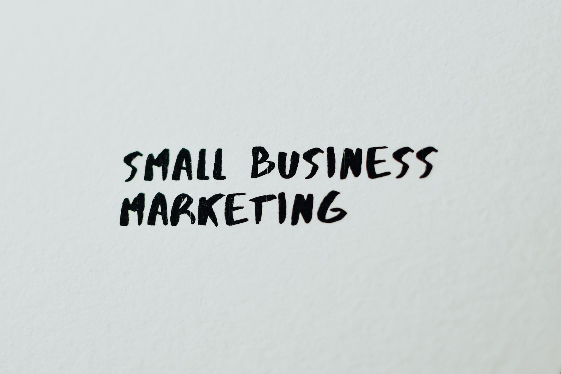 a piece of paper with the words `` small business marketing '' written on it 