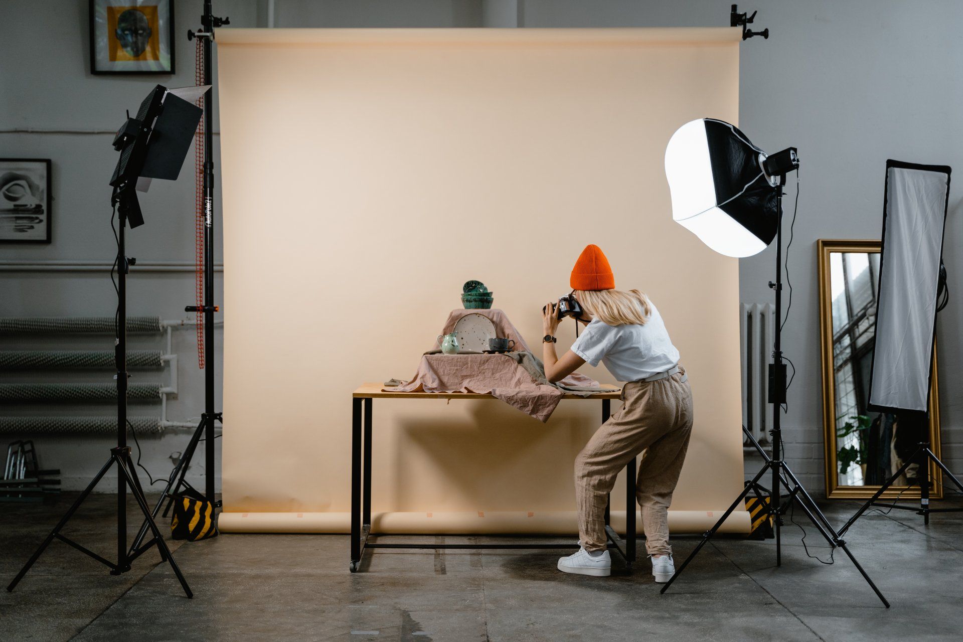 a woman is taking a picture of a table in a photo studio 