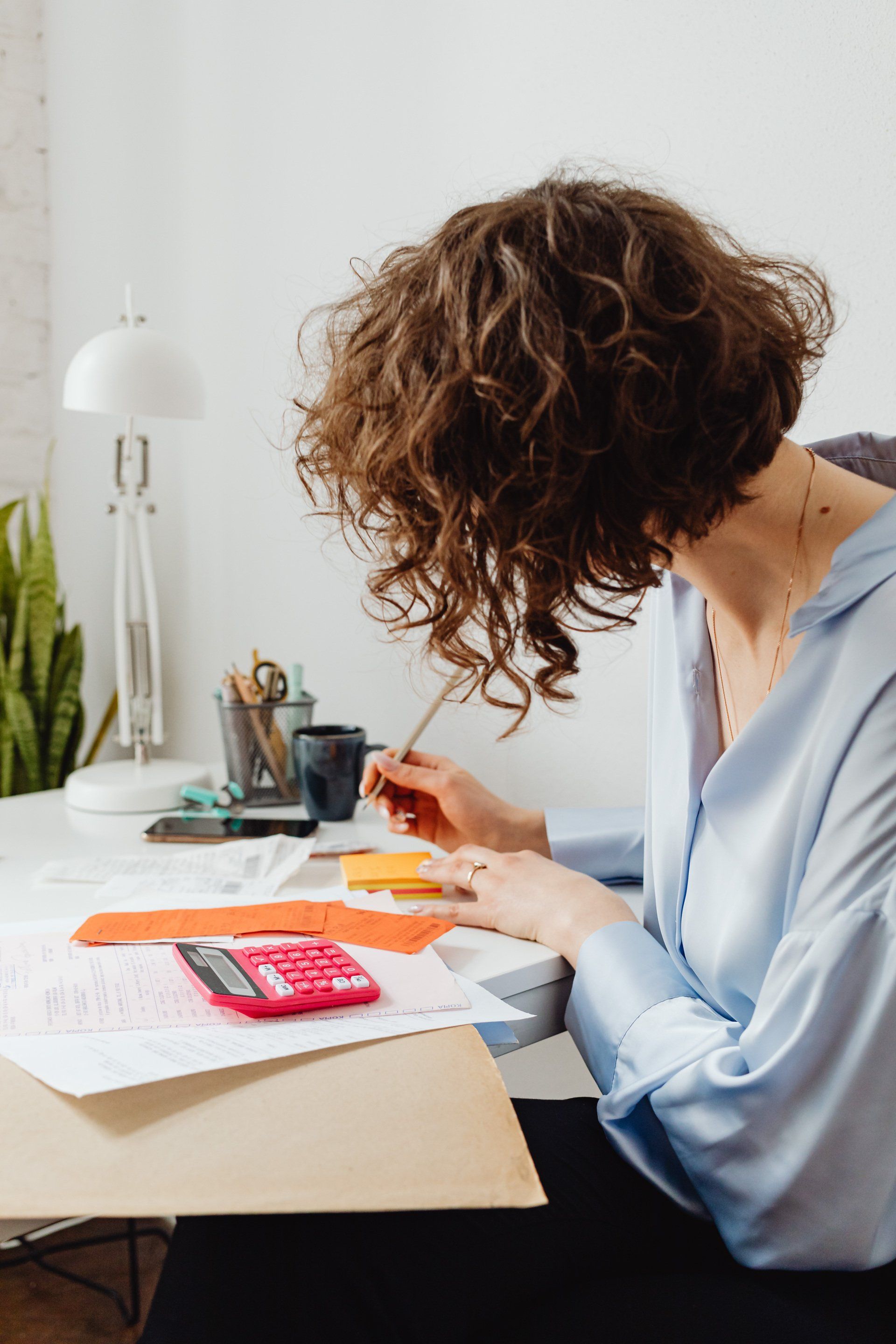 Female writing notes and planning how to protect her wealth and assests.