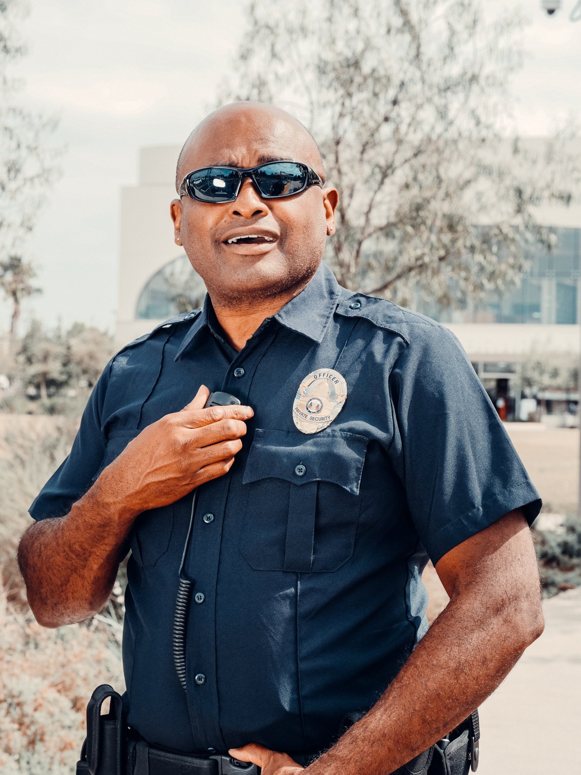 a police officer wearing sunglasses and a badge that says sheriff