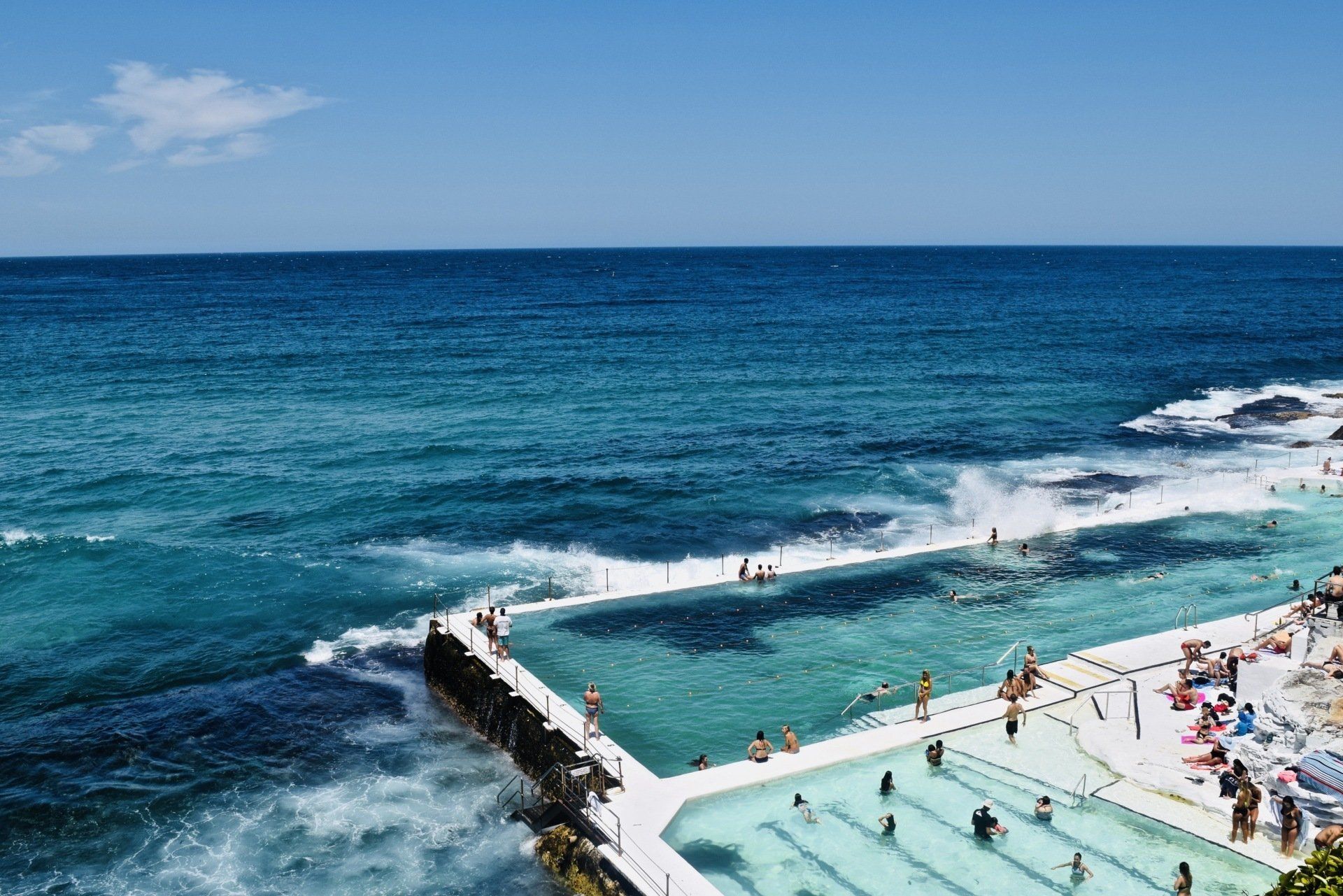A Group Of People Are Swimming In A Pool Next To The Ocean — One Stop Bookkeeping in Casino, NSW