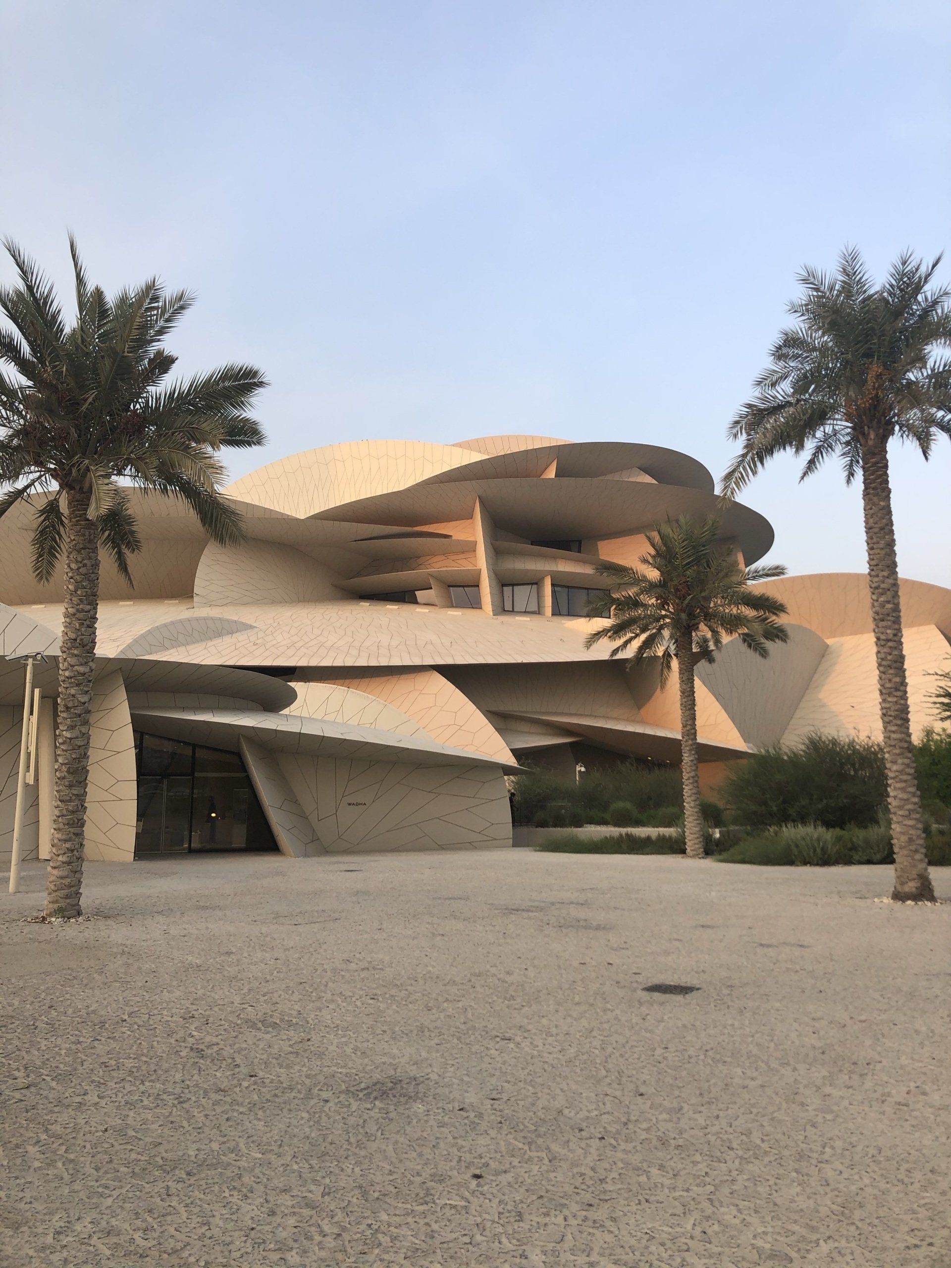 A large building with palm trees in front of it